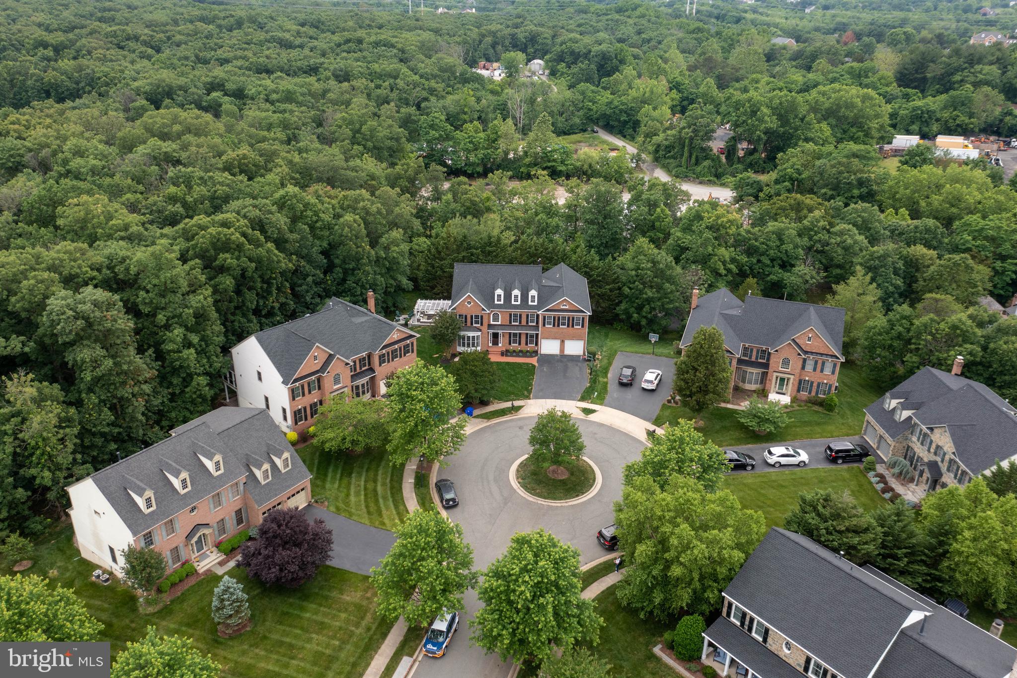 LOCATION & LIFESTYLE! This spectacular home was designed to seamlessly integrate indoor/outdoor living with a spacious and sun-filled interior.  Located in a highly desirable neighborhood with a layout that flows generously and spreads across four levels. Over 7,000 square feet, the owners have spared no expense to create the ultimate escape. Curl up in the luscious family room next to the fireplace, with floor-to-ceiling French windows and designer lush carpet.  The master suite offers a two-sided porcelain surround fireplace, sitting area, three walk-in closets, and a  pristine spa-inspired bathroom with porcelain tiles, double vanities with Carrara marble top, his and hers rainfall showerheads,  jetted tub, and water room.  The 2600 sqft, professionally designed basement is an entertainer's dream! Boasting a wet bar, in-law suite, exercise room, and exquisite finishes throughout. Grab a glass of wine and step out to the wonderful private retreat with a custom stone patio and a beautiful pergola to be enjoyed year-round! Gracefully appointed with six bedrooms, five full bathrooms, two powder rooms, a 4th level Bonus Room, an office on the main level, a sunroom off the kitchen area, and much more! This home will surely captivate the most discerning eyes!