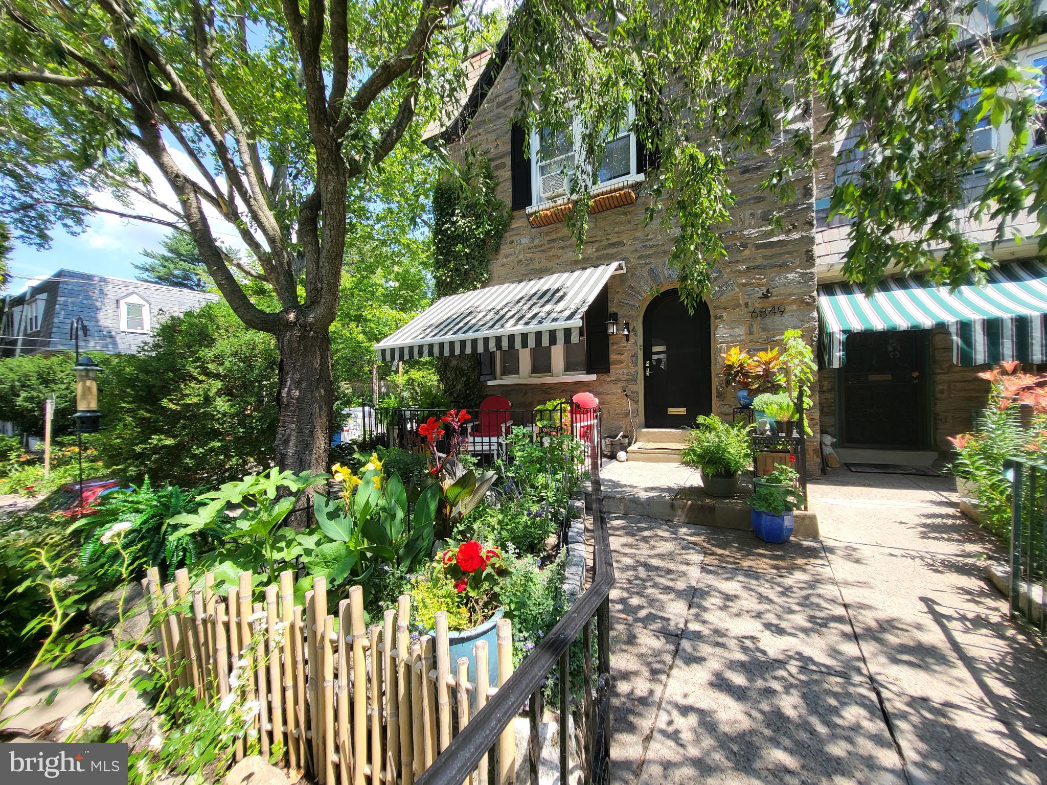Perched above one of East Mt. Airy's picturesque tree-lined streets, this beautifully maintained home offers charm, comfort, and thoughtful updates throughout. Relax on the secluded patio overlooking a stunning multi-tiered perennial garden, creating a peaceful outdoor retreat that's perfect for morning coffee or evening gatherings.
Inside, you'll find refinished original hardwood floors, multi-directional blinds, and a bright, welcoming living space. The formal dining room features charming wall sconces with coordinating overhead lighting, adding warmth and character for everyday dining or entertaining. A granite breakfast counter opens to the fully updated kitchen, complete with white appliances including a range, dishwasher, microwave, and refrigerator.
Upstairs, the spacious primary bedroom is complemented by two additional bedrooms and an updated full bathroom.
The unfinished lower level adds convenience with a recently installed powder room, laundry area with washer and dryer included, an exterior door to the side street, and direct access to the attached one-car garage. The garage, shared driveway, and additional street parking provide easy parking options.
Conveniently located near neighborhood parks, shopping, dining, and public transportation, this East Mt. Airy gem offers the perfect blend of classic character, modern updates, and comfortable living.