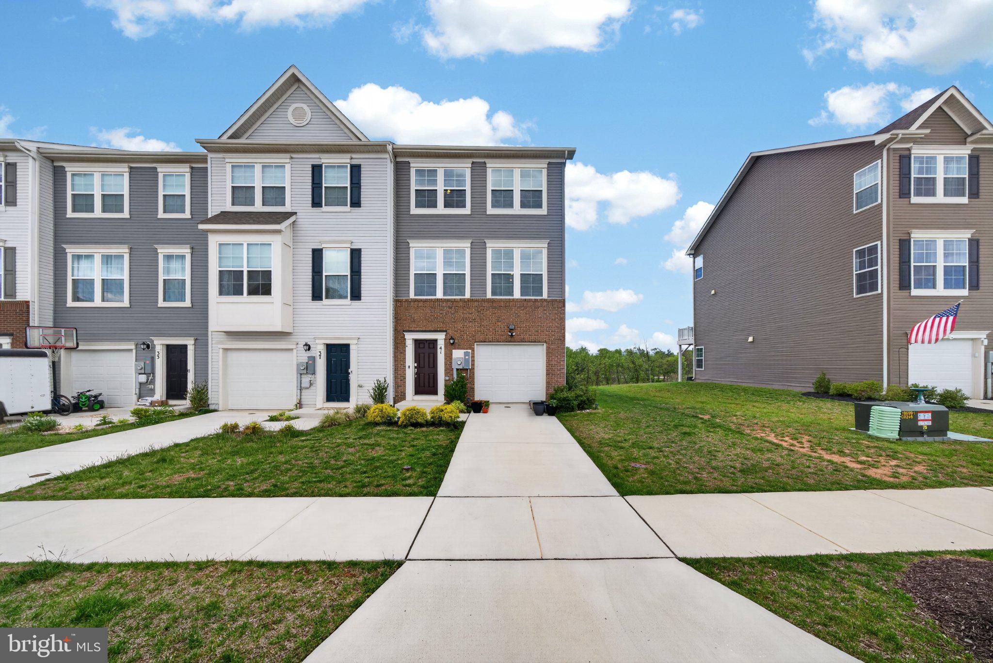 Welcome to Norborne Glebe, one of Charles Town’s most sought-after communities, where this beautifully maintained end-unit townhome offers enhanced privacy, open views, and thoughtful upgrades that truly set it apart from standard new construction. Built in 2023, this 3-level home features 3 bedrooms, 2 full baths, and 2 half baths with a functional open layout designed for modern living. Positioned as a desirable corner unit with no homes directly in front, this property captures peaceful sunrise and sunset views while offering a more open and spacious feel rarely found in townhome communities.

Unlike nearby builder-grade homes, this property is truly move-in ready with valuable upgrades already completed for the next owner, including ceiling fans throughout, window blinds installed, a water softener system, and a whole-home water filtration system, saving buyers thousands in additional expenses after closing. Buyers will also appreciate the advantage of moving into an already established section of the community without having to deal with ongoing nearby construction, constant contractor traffic, noise, dust, or unfinished surroundings often associated with purchasing directly from new construction communities. The entry level offers a versatile recreation space ideal for a home office, gym, or secondary living area with access to the backyard and peaceful surroundings.

The main level features an open-concept design with a spacious family room flowing seamlessly into the kitchen and dining area. Adding an upscale touch to the living space is a high-quality modern electric fireplace feature wall, creating a warm and luxurious focal point where the TV area is positioned. The kitchen includes granite countertops, stainless steel appliances, ample cabinet space, and a large center island perfect for entertaining or everyday living. Step outside onto the rear deck and enjoy added privacy along with open views that make this home stand out from the rest.

Upstairs, the primary suite offers a spacious retreat complete with a dual vanity ensuite bath, tiled shower, and generous walk-in closet. Two additional bedrooms, a full hall bath, and an upper-level laundry area complete the top floor.

A rare opportunity to own a newer end-unit home in Norborne Glebe with premium views, added privacy, luxury touches, and meaningful upgrades already completed for you.