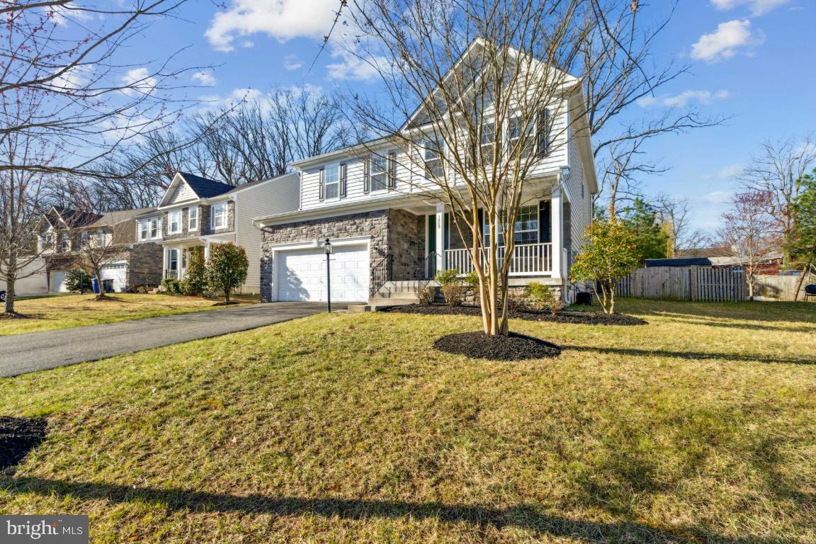 Welcome home to this beautiful, like-new residence spanning over 4,000 square feet with full  in-law or au pair suite. This four-bedroom, four-bathroom house features a spacious gourmet kitchen equipped with stainless steel appliances, granite countertops, and custom cabinetry. The extra-large living room, complete with a fireplace, flows into a bright and inviting sunroom, a dining room, and an oversized study, all located on the main level. The hardwood floors throughout have just been refinished, adding to the home's charm.  The open-concept design of the kitchen, living room, and sunroom provides direct access to a lovely, fenced yard that is perfect for entertaining. Upstairs, you will find a spacious open upper-level family or study area, along with four bedrooms. The oversized primary bedroom includes an ensuite bathroom and a walk-in closet. Additionally, there are three more generous-sized bedrooms and a large three-piece bathroom, as well as a laundry room on this level.  The lower level features walk-up exterior access and includes an enormous recreation room, an exercise room, and a perfect in-law or au pair suite with a full bathroom. There is also an unfinished utility room offering ample storage and shelving. The property boasts an oversized two-car garage, complete with racks and plenty of space for SUVs.  Conveniently located near commuter lots and I-95/HOT lane access, this home offers easy travel to the Pentagon, Arlington, and Washington, DC. Enjoy quick access to Wegmans and Potomac Mills, with a short five-minute drive to Quantico Marine Base.