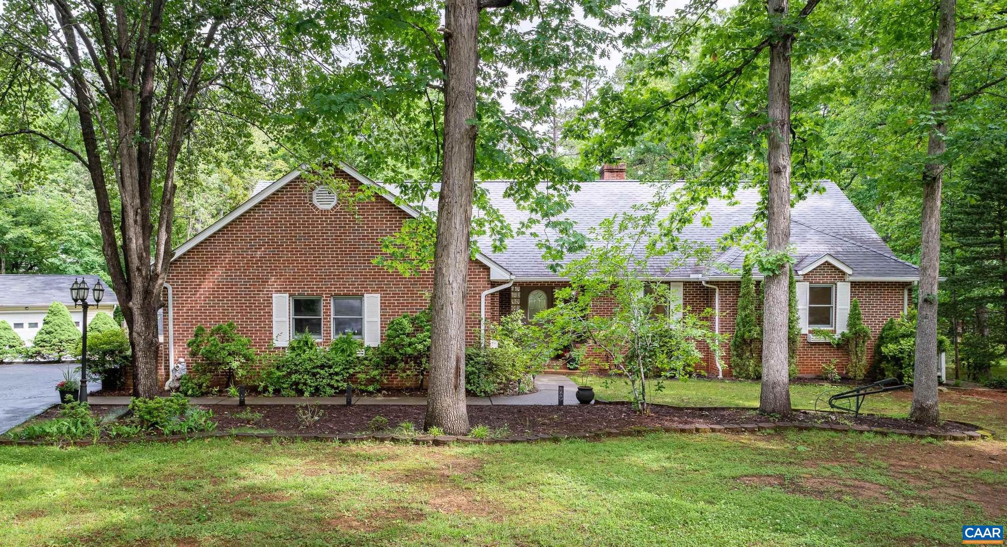 Luxury living in a GORGEOUS GEM in Lake Monticello! Custom-built, well-loved and meticulously maintained by one family. Relax and entertain in this all brick 5 bed/3 bath home on a private .67-acre lot at the end of the cul-de-sac. A welcoming foyer greets you before you step into the spacious living room with stone gas fireplace and door to the massive deck complete with gas line for grill, pergola and stairs to fire pit and lush grounds. The renovated eat-in kitchen is functional and warm with upgrades including painted cabinets, new hardware and hood/vent, new lighting and pantry barndoor.  Adjacent is the sunlit dining room with fresh paint and new chandelier. The large primary en suite is cozy and private, and there is a separate wing with two bedrooms and completely remodeled bathroom. The fully finished basement will WOW you with rec room, bar, two additional bedrooms, stunning bathroom with heated floor, office and utility/storage room. No detail or expense was spared in the lower level with built-in bookcases, built-in bar cabinetry, windows, separate entrance, and 3 mini splits.  Bonuses -heated detached garage, shed and garden potting station. Do not miss the small bridge crossing the creek to the back of the property!,Fireplace in Living Room
