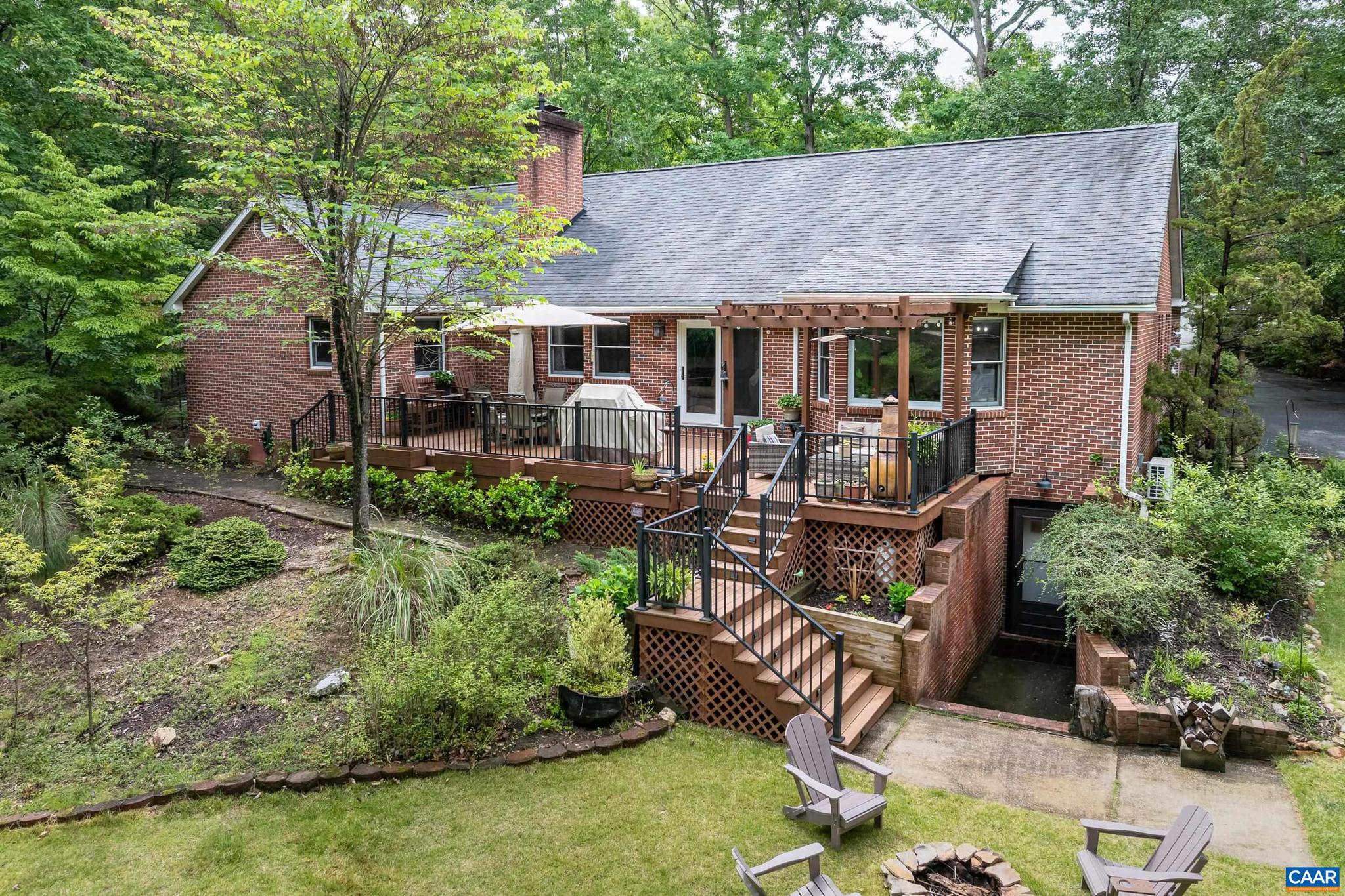 Luxury living in a GORGEOUS GEM in Lake Monticello! Custom-built, well-loved and meticulously maintained by one family. Relax and entertain in this all brick 5 bed/3 bath home on a private .67-acre lot at the end of the cul-de-sac. A welcoming foyer greets you before you step into the spacious living room with stone gas fireplace and door to the massive deck complete with gas line for grill, pergola and stairs to fire pit and lush grounds. The renovated eat-in kitchen is functional and warm with upgrades including painted cabinets, new hardware and hood/vent, new lighting and pantry barndoor.  Adjacent is the sunlit dining room with fresh paint and new chandelier. The large primary en suite is cozy and private, and there is a separate wing with two bedrooms and completely remodeled bathroom. The fully finished basement will WOW you with rec room, bar, two additional bedrooms, stunning bathroom with heated floor, office and utility/storage room. No detail or expense was spared in the lower level with built-in bookcases, built-in bar cabinetry, windows, separate entrance, and 3 mini splits.  Bonuses -heated detached garage, shed and garden potting station. Do not miss the small bridge crossing the creek to the back of the property!,Fireplace in Living Room