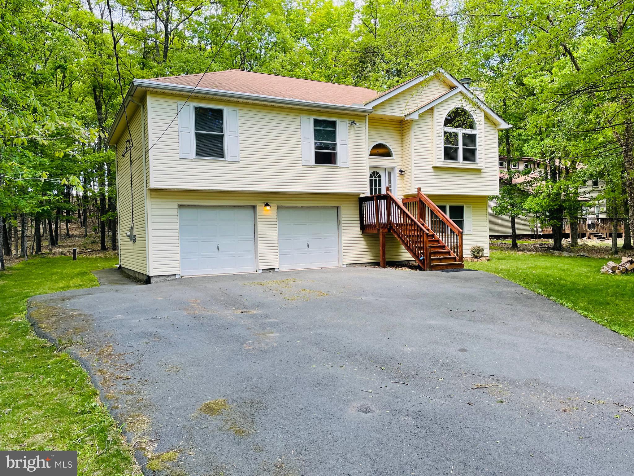 CHARMING SPLIT‑LEVEL HOME with CENTRAL A/C and CENTRAL HEAT, built in 2008, offering STRONG VALUE‑ADD POTENTIAL, negotiable FURNITURE, and located in a highly desirable AIRBnB‑friendly community.
Set on a serene, WOODED LOT, this BRIGHT and airy home offers comfortable MOVE-IN-READY living with exceptional EXPANSION POSSIBILITIES.

The main level features three well‑sized bedrooms and two full baths, creating an efficient layout for everyday living. 
The EXPANSIVE unfinished lower level is a standout OPPORTUNITY—already framed with   ADDITIONAL ROOMS and rough‑in plumbing for a THIRD FULL BATH. Finish the space to CREATE a 4-5‑BEDROOM home, an IN-LAW SUITE, or a LARGE RECREATION/BONUS AREA, unlocking IMMEDIATE EQUITY and long‑term flexibility.
Enjoy OUTDOOR LIVING on the DECK with a concrete PATIO and the PRIVACY of a SPACIOUS, tree‑lined 0.69‑ACRE  lot. 
A TWO-CAR GARAGE and WIDE PAVED DRIVEWAY provide ample parking and storage.

Located in an STR‑friendly gated community with low ANNUAL DUES under $1,500, residents enjoy access to FIVE LAKES offering non‑motorized activities such as FISHING, KAYAKING, and CANOEING. Additional AMENITIES include 2 outdoor SWIMMING POOLS, a KIDDIE POOL, 4 TENNIS COURTS, and 2 BASKETBALL COURTS. The community provides 24‑hour security, road maintenance, and trash removal for added convenience.
Perfectly positioned near I‑80, the PA Turnpike, Pocono Raceway, and multiple ski resorts, this home offers both tranquility and accessibility.
Ideal for investors, STR buyers, or anyone seeking a customizable home with strong upside. Finish the lower level to your taste and maximize the property’s full potential.
Schedule your private showing and explore the possibilities.