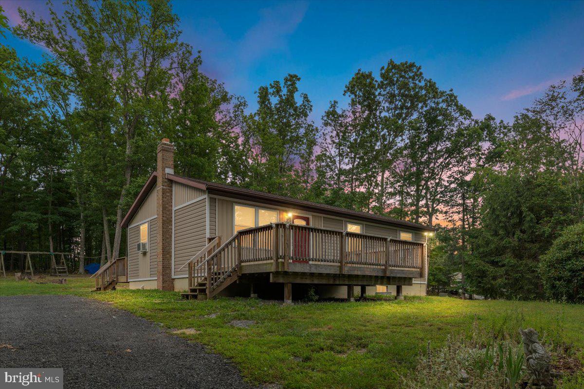 Enjoy comfortable living at 230 Swallow Place in Berkeley Springs, West Virginia. This three-bedroom, two-bath rancher is situated on 2.73 acres and offers a desirable blend of privacy, usable space, and convenience. Features include a large front deck, partially finished basement, exterior storage building, and a wood stove in the basement. The location offers convenient access to the new bypass currently being completed, as well as nearby downtown Berkeley Springs with its historic charm, local shops, restaurants, and amenities. A wonderful opportunity for buyers seeking acreage, convenience, and the lifestyle Berkeley Springs has to offer. Internet and cable, Xfinity