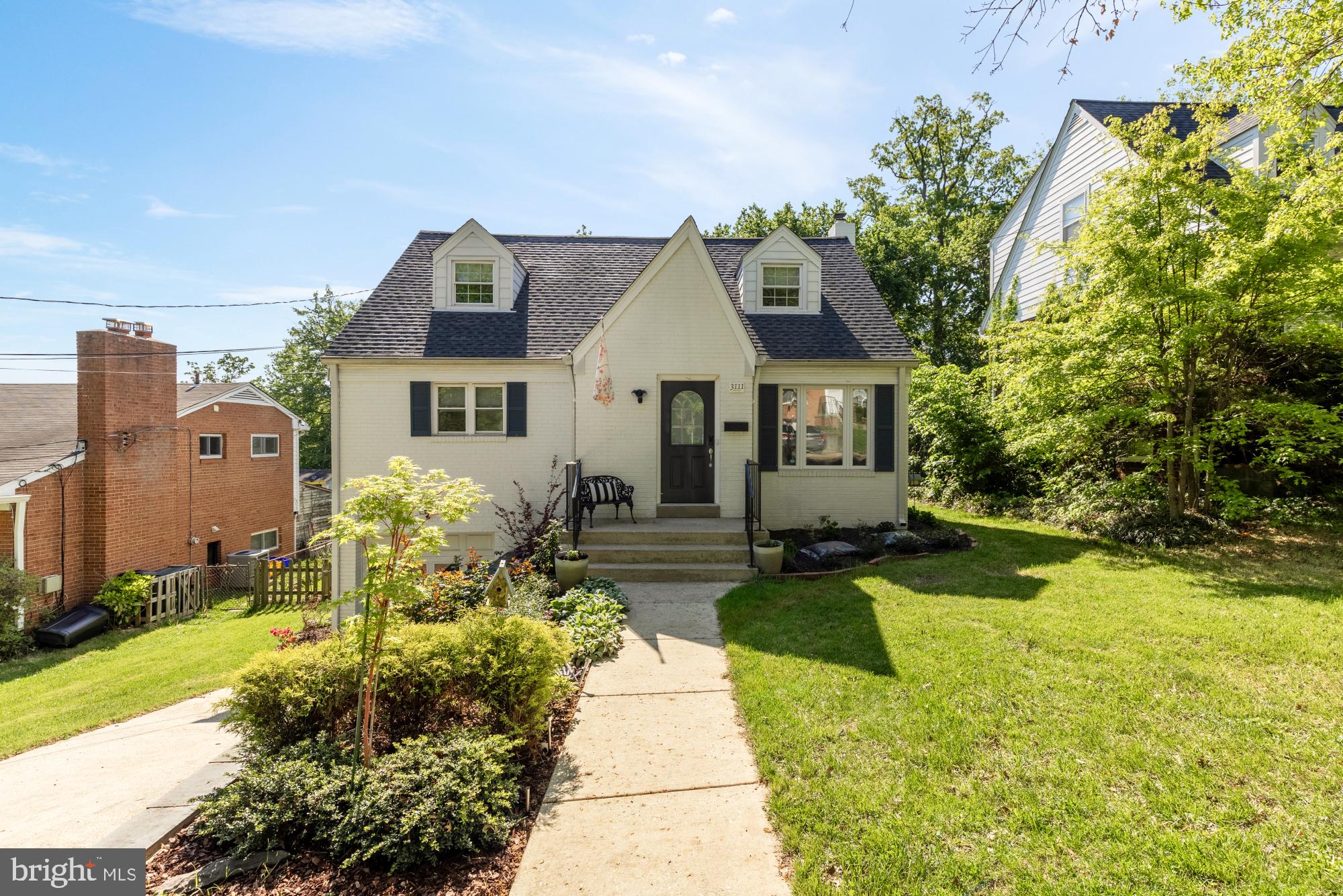 Set on an expansive nearly 10,000 square foot lot in the heart of Cheverly, 3111 63rd Place offers a rare combination of scale, light, and livability—just minutes from the city. The home is thoughtfully laid out across three levels, balancing a traditional layout with flexibility for modern living, and features a new roof (2025).

The main level is both functional and inviting, anchored by a light-filled living room featuring custom built-ins and an electric fireplace, creating a natural focal point for the space. Warm wood flooring carries throughout, connecting the living room to a dedicated dining area and a centrally positioned kitchen that opens directly to the rear patio—an easy transition for indoor-outdoor living. Two bedrooms and a full bath on this level offer flexibility for guests, work-from-home needs, or convenient single-level living.

Upstairs, two additional bedrooms are complemented by a full bath and added storage, providing a thoughtful separation from the main living areas.

The lower level adds meaningful everyday utility, featuring a recreation room, laundry area, mechanical space, and direct access to the attached one-car garage, along with generous storage throughout.
What truly sets this property apart is the lot. Stretching nearly a quarter acre, the backyard extends far beyond what is typical for the neighborhood—offering a deep, private green setting with ample space to entertain and garden.

This home is conveniently located near several parks, including Cheverly Community Park and Bladensburg Waterfront Park, as well as the famous Cheverly Swim & Racquet Club! Nearby grocery and shops include Whole Foods, Wegmans and Aldi. Easy access to Washington DC, Annapolis and Baltimore. Welcome home!