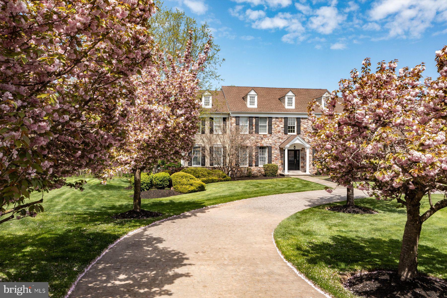 Situated on a prime 2.88+ acre site in the community of Meadowood, this expansive custom-built 
stone fronted home features three levels of living space, five en-suite bedrooms, a full finished 
daylight walk-out lower level, and an array of outdoor amenities including a  heated salt 
water pool with diving area and waterfall, basketball court, sprawling wrap-around deck, and paver  
terraces for entertaining. A circular driveway to the double front door leads to a center foyer, flanked by 
formal living room and dining rooms, the dining room with Butler area with built-ins and granite 
counters.  A conservatory with tile floor and window surround is a great respite for watching TV, 
reading, or enjoying guests. A spacious step-down great room is enhanced by a stone gas fireplace 
and custom floor-to-ceiling built-in bookcases and shelving. Nearby is a large, sunny
kitchen/breakfast room, with a Viking gas range, center island with granite counters, and room for a 
dining table for everyday enjoyment.  A solarium just off the kitchen allows access to a two-level 
composite deck, overlooking the private rear yard and pool area below. The first floor also offers 
two powder rooms, a laundry with built-ins, and access to the oversized 3-car side entry garage. 
Upstairs, the gracious main bedroom suite includes a his/hers bath, joined by a shower for 
two, and a jetted tub, and large walk-in closets. In addition, four en-suite bedrooms have been 
enhanced with newer laminate “wood” flooring, each with a tile bath with tub and shower head.  
The lower level, a full walk-out with double hung windows, has ample entertainment space with a 
gathering room, game room, media room with projector and screen, gym with mirrored wall and 
specialty flooring, kitchenette, and flex room and full bath, great for in-law quarters or extra company. There is also a workbench/utility room with double door access to the outdoors- handy for lawn, garden and patio furniture storage. The rear yard backs to woods, and is extremely private, beautifully manicured, and its own mecca for enjoyment.  In addition to the oversized pool with diving area, a basketball/sports court could also be converted to a pickle ball court, or riding bikes or roller skating. There is also a storage she, and a nearby garden with a water source available.  With meticulous landscaping and flowering 
trees and shrubbery,  garden irrigation, a back-up generator, newer roof, zoned HVAC, central music 
and central security, this private oasis on almost 3 acres epitomizes a wonderful lifestyle amidst natural 
beauty, with room for everyone, in a highly convenient location in Upper Makefield.