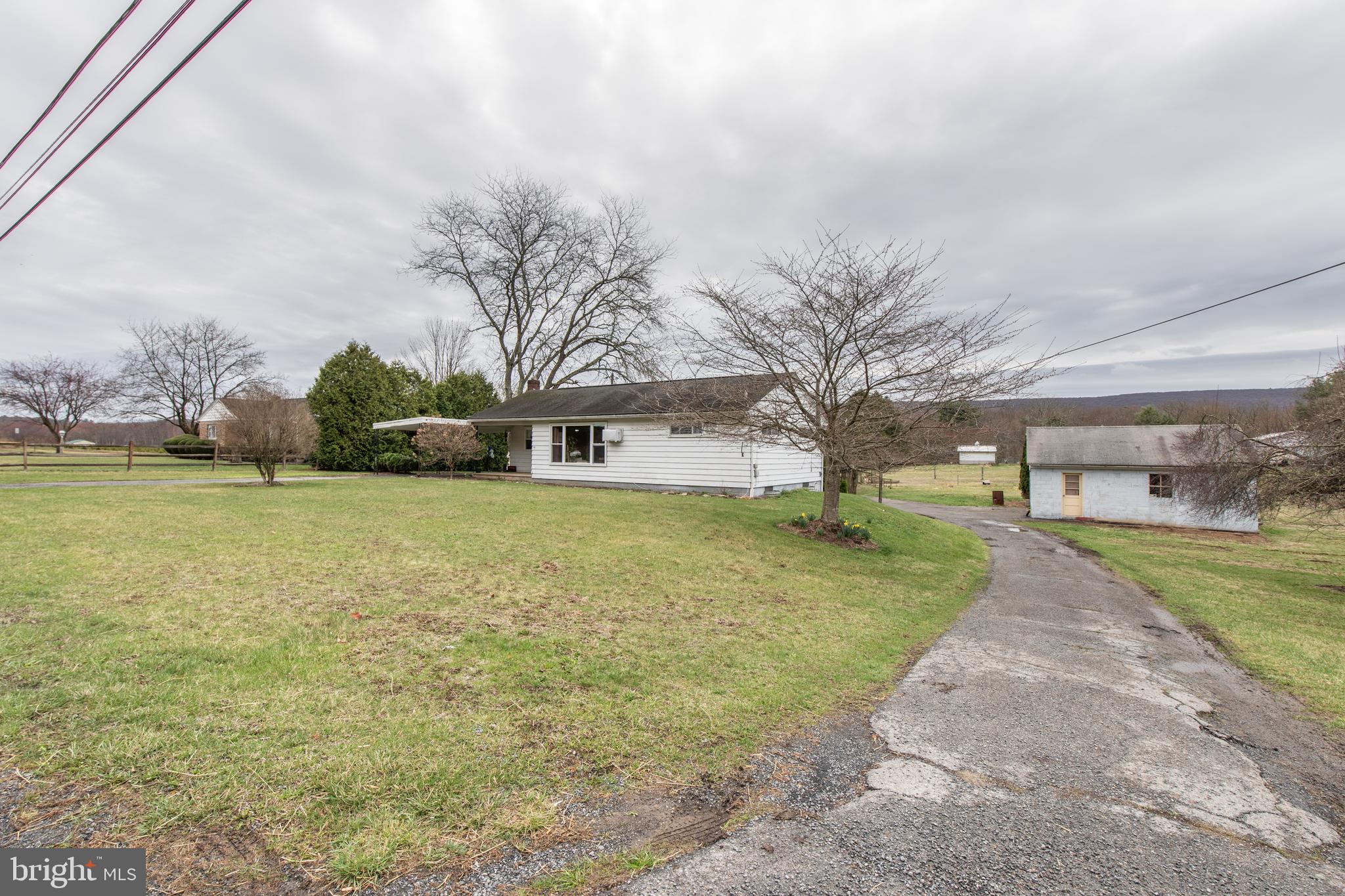 Enjoy single story living on a level 1.5 acre lot with views of the Blue Mountain.  Located between routes 309 and 61 this three bedroom ranch home is ready for a new owner! The interior has a large eat-in kitchen with plenty of counterspace.  The living room and the bedrooms have hardwood floors throughout.  The home has updated mechanicals.  A new 200 amp electric panel, new electric hot water heater, water treatment system, and a newer oil burner.  The exterior of the home has a covered carport that leads into the kithcen.  The basement has a one car garage entrance and over a 1,000 square feet of open space.  Detached from the home is a two car garage with an attic space for storage or a workshop.  Do not miss the opportunity to own the rancher everyone asks about!!