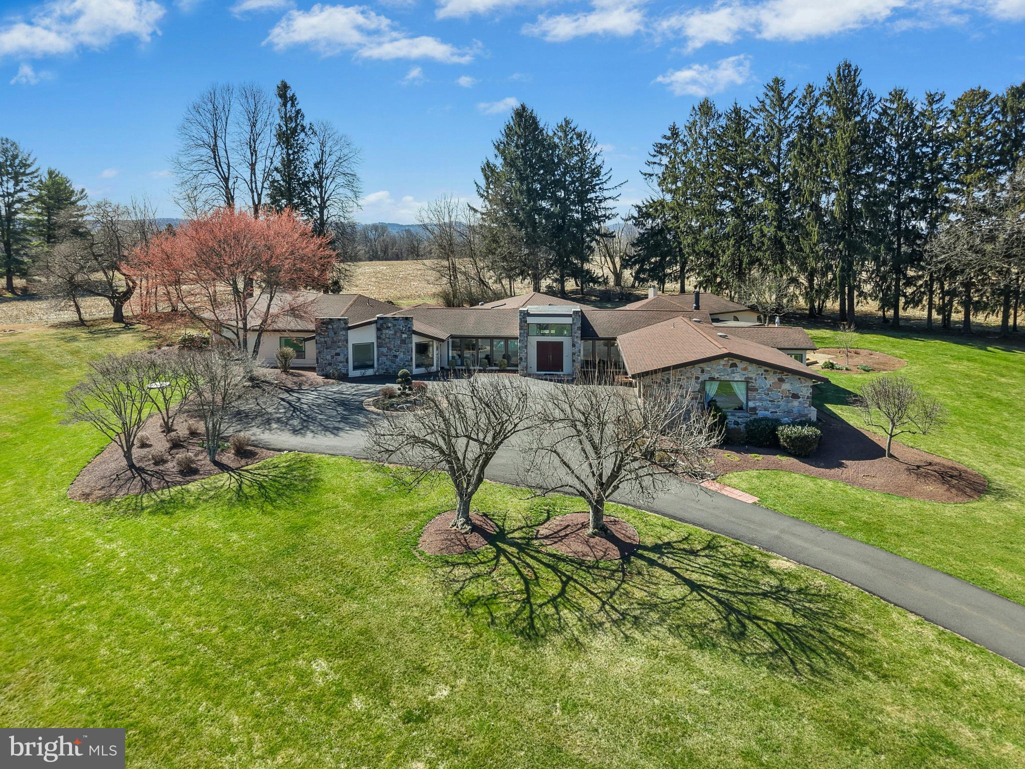 MULTIPLE OFFERS RECEIVED.  PLEASE CONTACT LISTING AGENT IF INTERESTED.
THE OASIS 
A private cul-de-sac is the setting for this extraordinary home offering single-floor living in the heart of the Lehigh Valley. The ultra-convenient location stands minutes from Cedar Crest Boulevard, Lehigh Country Club, Lehigh Valley Hospital and I-78.  

This remarkable contemporary residence was built in 1975 and sits on over 3 acres of mature landscaping and lush gardens. Open and airy living spaces are filled with natural light and designed for both comfortable living and elegant entertaining. Formal living and dining rooms are found in the front of the house, with a large family room and well appointed chef’s kitchen nearby. A sunny breakfast room, office/flex room, laundry room, and full bath complete this wing of the home. The primary suite is luxurious with plush carpet, a raised platform bed, and separate sitting areas. Dual baths and closets make this space both unique and practical. Also in this wing is a separate suite, and two hall bedrooms with built-in beds as well as an updated full bath. 

The piece de resistance is of course the indoor pool, a private retreat in the center of this incredible home. With walls of windows on all sides, the heated inground bromine pool has a retractable cover, vaulted ceiling with skylights, and access to both the interior of the house as well as the grounds beyond.