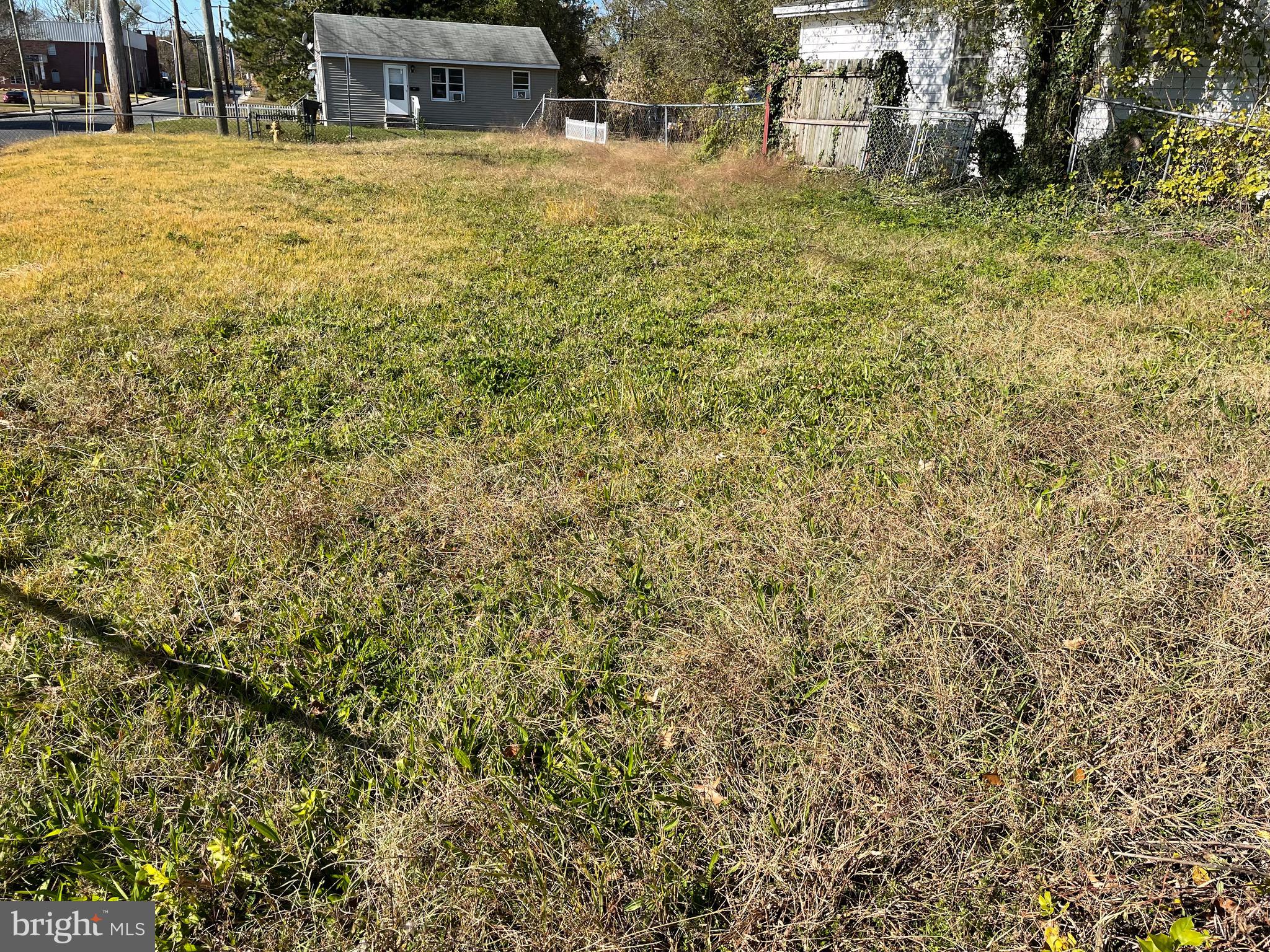 In Salisbury City limits, this cleared, corner and zoned buildable lot is surrounded by a chain link fence. The new owner must purchase a building permit and set backs on this lot.