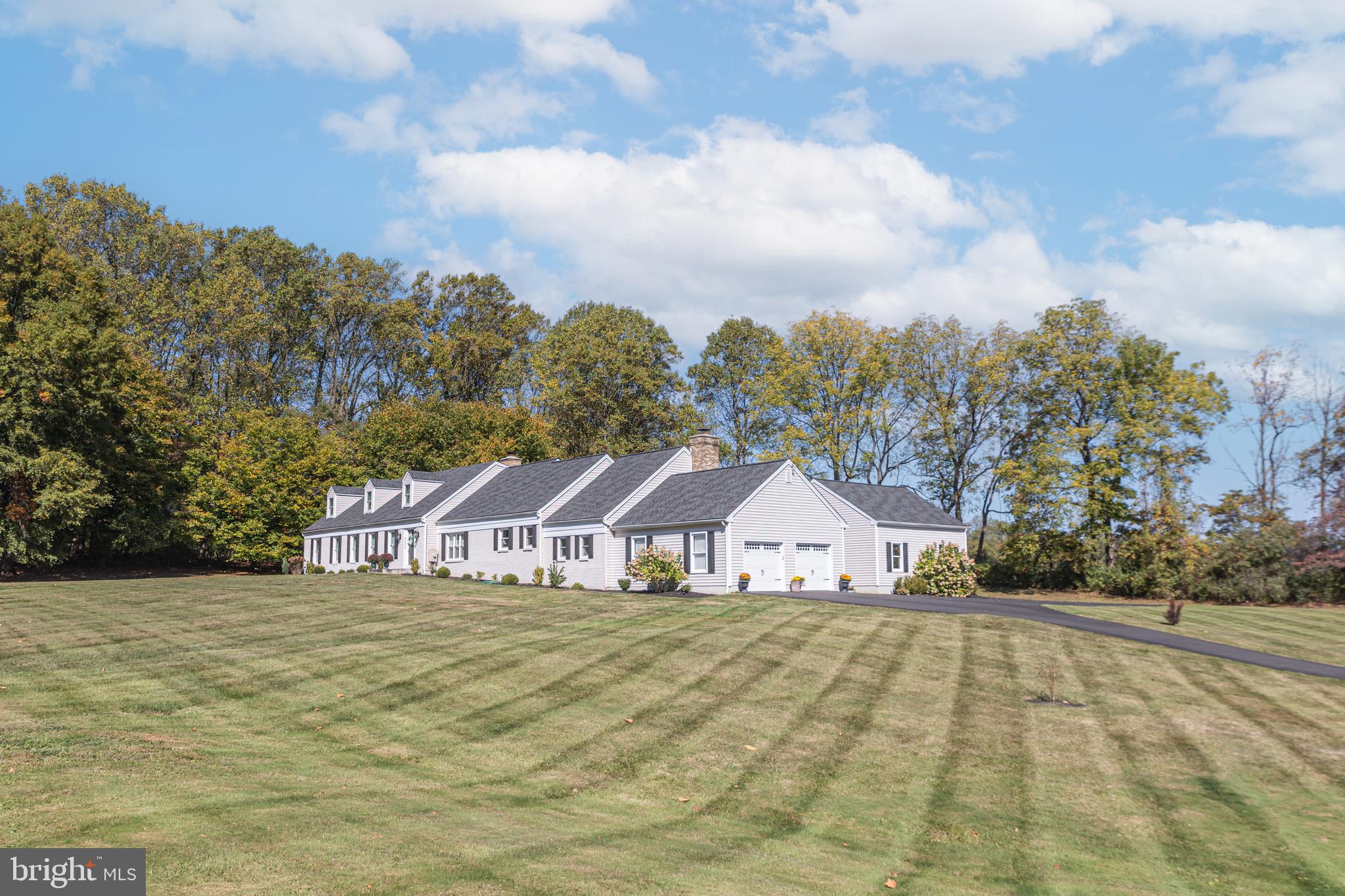 Beautifully renovated 5 bedroom home on almost 3 private acres within New Hope – Solebury schools. Move-in ready, open concept and incredibly versatile; live on just the main level or take advantage of the additional living space on the 2nd floor. The gourmet kitchen is a showstopper, thoughtfully designed with everything you need: New stainless appliances, New custom cabinetry, New granite countertops and Expansive island with seating for 6. This fabulous space unites the cozy Family Room with wood-burning fireplace, formal Dining and Living Rooms providing ample space for entertaining. The 1st floor Primary Suite is luxurious and tucked away featuring a lovely sitting area, enormous walk-in closet and a gorgeous bathroom highlighting a freestanding tub and frameless shower with rain-head. Relax on the new paver patio and relish the sounds of nature and the wonderful privacy or play in the flat usable yard. Additional amenities include a New roof, New siding, New driveway, New HVAC systems, whole house generator, all bathrooms have been updated and 4 car attached garage with finished bonus space.  Less than 1 mile to the elementary school and only 4 miles to downtown New Hope for shopping, dining and entertainment. Incredible value in a picturesque setting!