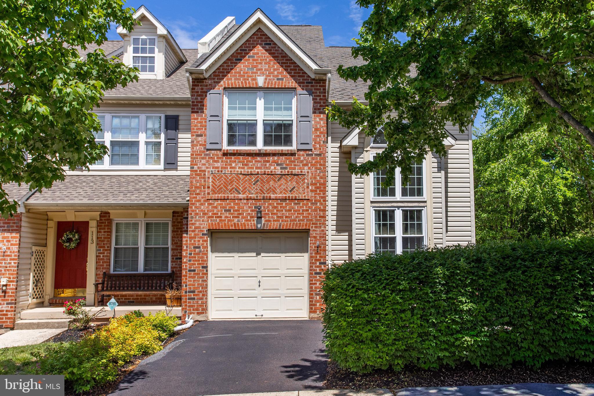 Absolutely stunning end-unit townhome in the highly desirable Williamsburg Village community. Impeccably maintained by its original owners, this light-filled home boasts soaring ceilings and pride of ownership throughout. Enjoy the ultimate convenience of a prime location with effortless access to major highways, premier shopping centers, and top-rated local schools.

The main level welcomes you with a dramatic two-story living room, flowing into an open-concept dining area and a cozy family room featuring a classic fireplace. The adjacent eat-in kitchen is equipped with a center island, perfect for casual dining. This level also includes a convenient powder room, garage access, and entry to a private rear deck overlooking a serene, wooded setting.

On the second floor, a charming Romeo-and-Juliet balcony overlooks the living room below. This level features three spacious bedrooms, including a luxurious primary suite with a large walk-in closet and a spa-like en suite bath complete with a skylight and a two-person Jacuzzi tub. A hallway full bath and a dedicated laundry room add ultimate convenience.

The third-floor loft serves as a bright fourth bedroom, flooded with natural light from large windows and skylights. 

Downstairs, the finished basement expands your living space with a large home theater area, an additional half bath, a utility room, and a generous unfinished space for all your storage needs. 

This turnkey home is sure to impress—schedule your private tour today