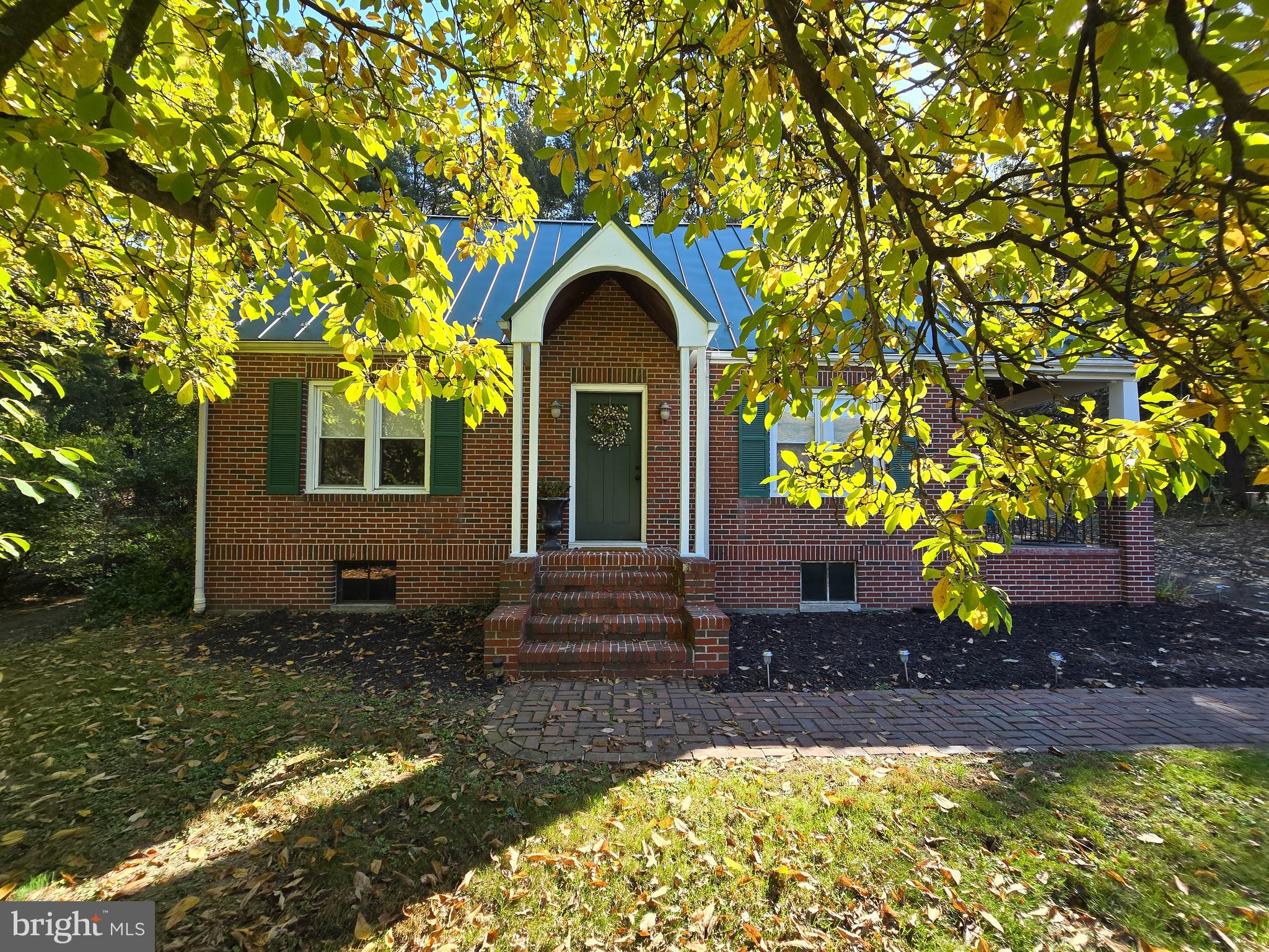 ABSOLUTELY CHARMING!!!  This vintage, brick Cape Cod home is situated on .7 acres less than 2 miles from downtown Berkeley Springs, WV (Town of Bath) with all of its shops, spas, and restaurants!  The home features wood flooring throughout as well as charming accents such as glass knobs and archways.  The main level conveys a kitchen with tile countertops, farm sink, and gas range, as well as separate dining area, living room including a brick fireplace surround and access to the front porch and side porch, two sizable bedrooms, and a full bath with tile flooring and walk-in shower with bench seat.  The serenity sets in when you walk upstairs to the primary bedroom featuring a sitting area, closet with barn door, as well as the ensuite bathroom complete with decorative glass accent windows and substantial soaking tub!  The laundry area is located in the unfinished basement of the home along with a root cellar, access to the exterior bilco door, and flue for a potential woodstove.  Outside of the home presents plenty of yard space, side/rear patio, as well as a detached garage.  Although the home was constructed many years ago, several updates have been made to include a metal roof and gutters (2008), central air/heat pump (2023), plumbing (2008), electrical including panel box, and much more!  There are endless possibilities for this property as it can be used as a primary residence, rental/Airbnb, commercial, or whatever suits your needs!  This delightful home is a MUST SEE!