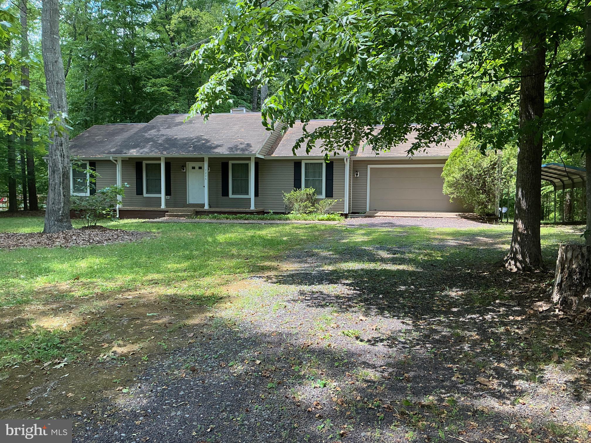 Great lake home or starter home for 1st time home buyers with 3 bedrooms, 2 bathrooms, a gas fireplace in the dining room, and approximately 1400 sq. ft., finished with an oversized garage and carport. The house has a newly installed conditioned crawlspace. In addition to the amenities, a boat slip in the Common Area conveys.  The home has been well-maintained and has significant potential to increase in value.  It is in a wonderful community with a common area, a large picnic area, boat docks, and a boat ramp.