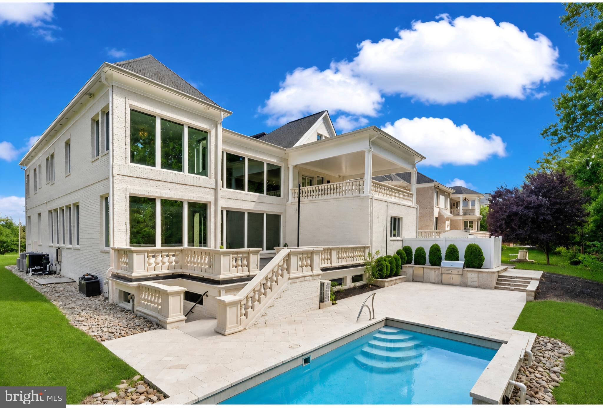 A glass-and-light modern masterpiece, this custom residence by Potomac Custom Homes spans nearly 10,000 finished square feet on a quiet cul-de-sac in The Reserves at Pinecrest, privately backing to protected Fairfax County parkland. Expansive walls of glass and dramatic vertical spaces set an unforgettable tone, anchored by soaring 20-ft ceilings in the main living area and the primary sitting room, with 10-ft ceilings throughout the rest of the home. A custom floating staircase wrapped in fully enclosed glass railings rises through every level, while large-format Roberto Cavalli porcelain flooring and radiant heat bring warmth and cohesion to the main living spaces.

At the heart of the home, a chef's kitchen is designed to impress: custom Italian UNICA cabinetry, 3-inch DEKTON Aura waterfall countertops, a professional GE Monogram appliance suite with induction range, and an expansive island built for gathering. GROHE designer fixtures and copper supply lines reflect a commitment to quality throughout.

Designed for entertaining and everyday escape, the finished lower level delivers a dedicated home theater, a golf simulator room with an $80K build-out, and a private gym, with theater seating, projector and screen, and gym equipment all conveying.

Outdoor living rivals a private resort. A saltwater fiberglass pool with Pentair heating, LED lighting, a decorative waterfall, and an automatic cover is surrounded by an expansive patio with a built-in Weber gas grill, outdoor refrigerator, and integrated storage. Upstairs, the primary suite opens to a private balcony retreat with a hot tub overlooking the trees.

Smart and built to last, the home features Control4 whole-home automation, a hardwired security system, a full-house Generac backup generator, three-zone Carrier HVAC, and app-controlled Rachio smart irrigation. A spacious 4-car garage with 8-ft doors, epoxy floors, and custom storage, plus a mudroom with a built-in pet-washing station, complete the offering.

Minutes to I-495, I-395, Route 236, Route 7, and Braddock Road, with parks, golf courses, shopping, and dining close by, this is contemporary luxury with a true sense of retreat in the heart of Northern Virginia.