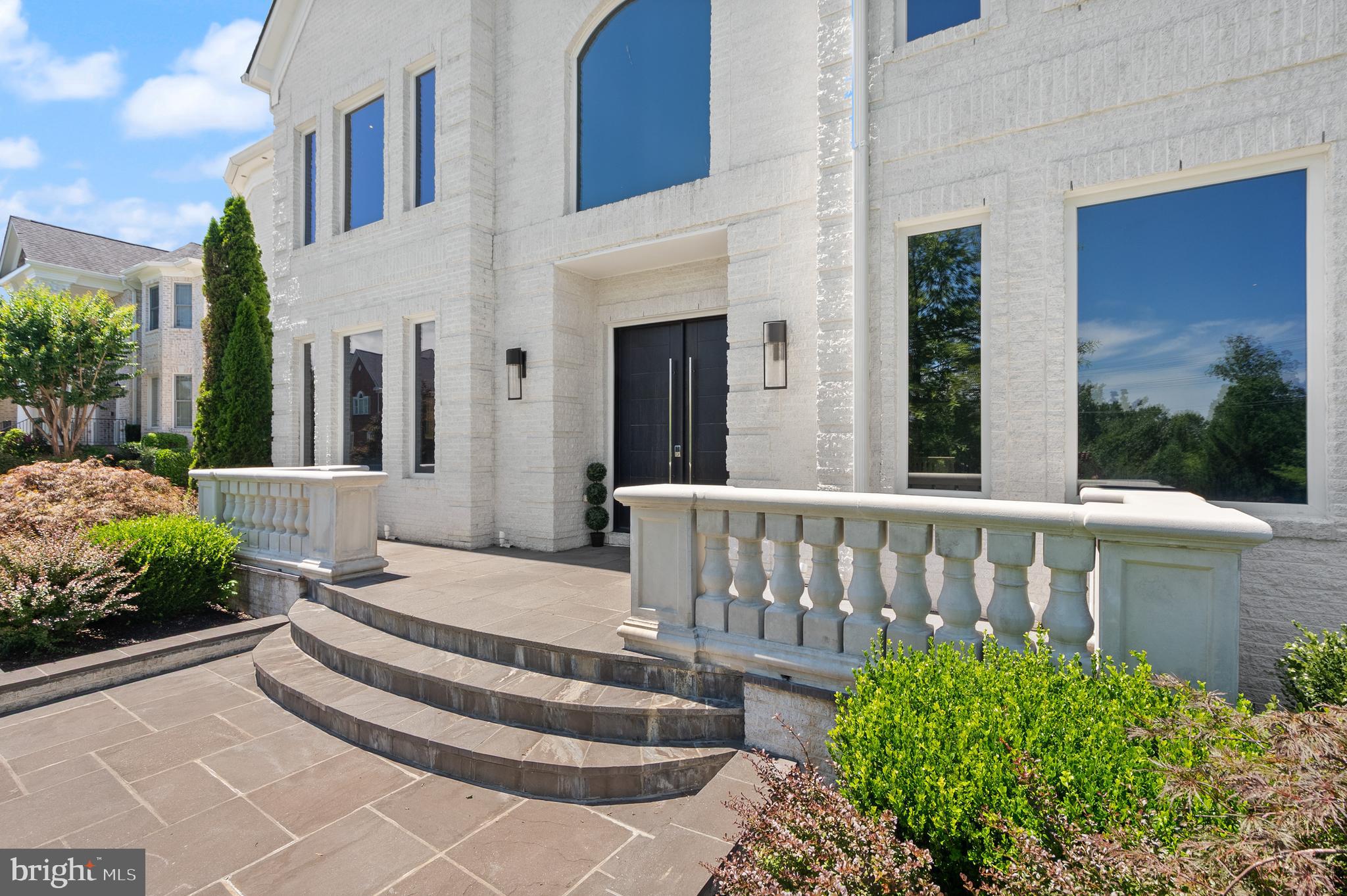 A glass-and-light modern masterpiece, this custom residence by Potomac Custom Homes spans nearly 10,000 finished square feet on a quiet cul-de-sac in The Reserves at Pinecrest, privately backing to protected Fairfax County parkland. Expansive walls of glass and dramatic vertical spaces set an unforgettable tone, anchored by soaring 20-ft ceilings in the main living area and the primary sitting room, with 10-ft ceilings throughout the rest of the home. A custom floating staircase wrapped in fully enclosed glass railings rises through every level, while large-format Roberto Cavalli porcelain flooring and radiant heat bring warmth and cohesion to the main living spaces.

At the heart of the home, a chef's kitchen is designed to impress: custom Italian UNICA cabinetry, 3-inch DEKTON Aura waterfall countertops, a professional GE Monogram appliance suite with induction range, and an expansive island built for gathering. GROHE designer fixtures and copper supply lines reflect a commitment to quality throughout.

Designed for entertaining and everyday escape, the finished lower level delivers a dedicated home theater, a golf simulator room with an $80K build-out, and a private gym, with theater seating, projector and screen, and gym equipment all conveying.

Outdoor living rivals a private resort. A saltwater fiberglass pool with Pentair heating, LED lighting, a decorative waterfall, and an automatic cover is surrounded by an expansive patio with a built-in Weber gas grill, outdoor refrigerator, and integrated storage. Upstairs, the primary suite opens to a private balcony retreat with a hot tub overlooking the trees.

Smart and built to last, the home features Control4 whole-home automation, a hardwired security system, a full-house Generac backup generator, three-zone Carrier HVAC, and app-controlled Rachio smart irrigation. A spacious 4-car garage with 8-ft doors, epoxy floors, and custom storage, plus a mudroom with a built-in pet-washing station, complete the offering.

Minutes to I-495, I-395, Route 236, Route 7, and Braddock Road, with parks, golf courses, shopping, and dining close by, this is contemporary luxury with a true sense of retreat in the heart of Northern Virginia.