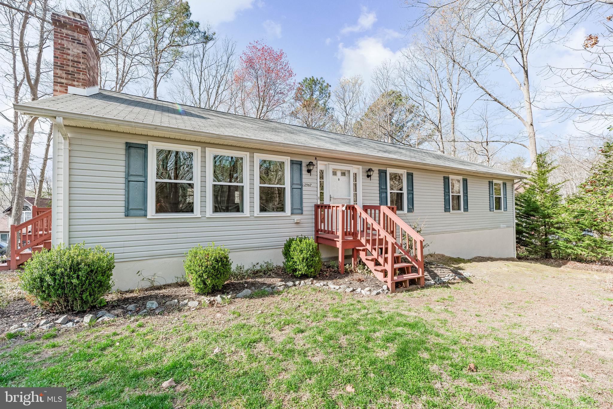 Spacious and versatile, this 5 bedroom, 3 bathroom home offers over 3,600 square feet of living space on a private lot in Lusby. Designed with an open floor plan, the main level features multiple bedrooms, a bright living area with a wood stove, and an updated eat in kitchen with granite countertops, and stainless steel appliances.

Step outside to a rear deck ideal for grilling and entertaining, with a peaceful setting surrounded by trees.
The fully finished walkout basement expands the living space with a large family room, game room, additional bedroom or office, laundry area, and flexible space for hobbies or storage.

Located just outside Chesapeake Ranch Estates while still enjoying access to its amenities, including beaches, lake, clubhouse, and more, this property combines privacy with convenience to schools, shopping, and Solomons Island.