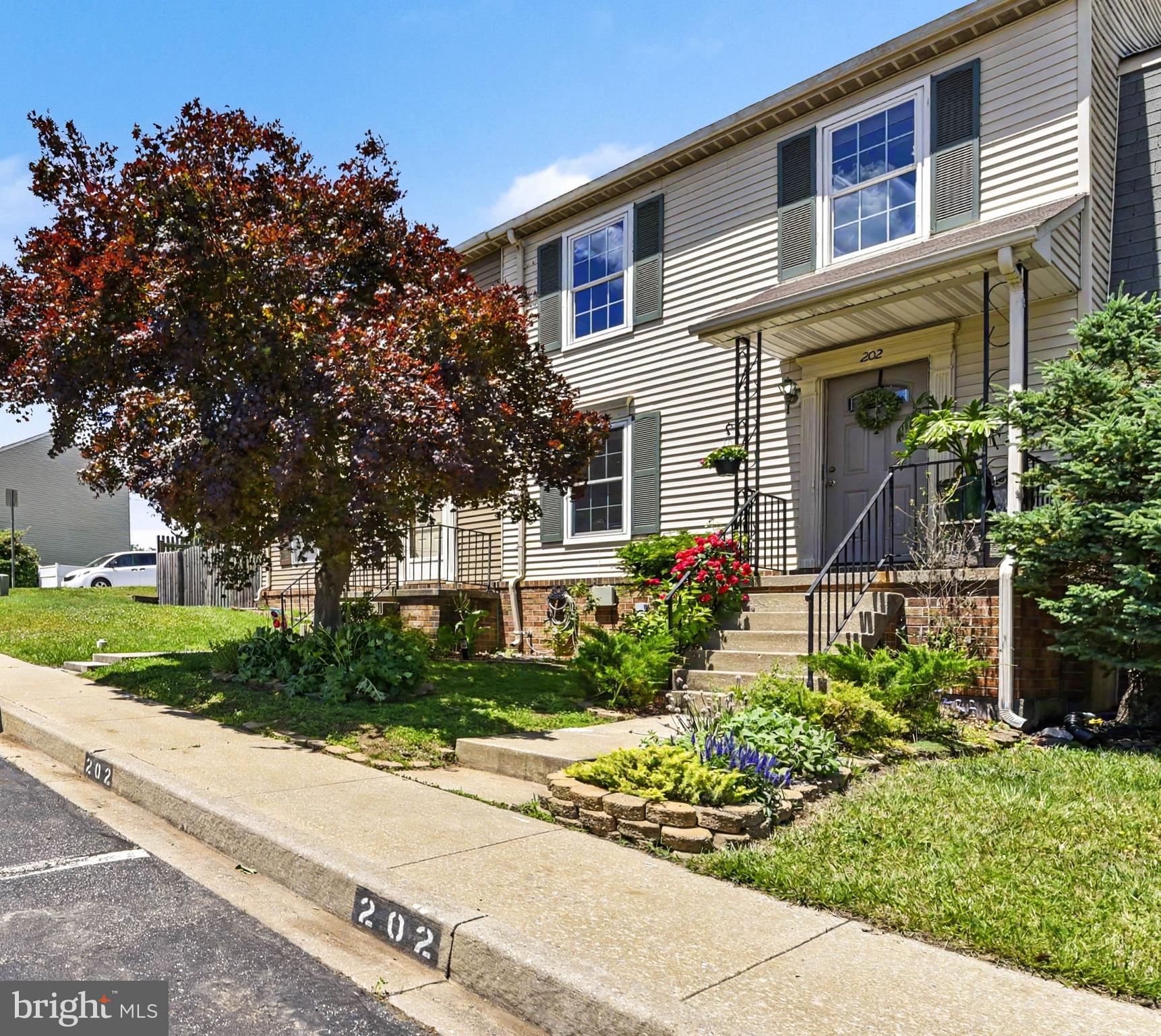 This pristine, updated townhome truly shows pride of ownership, featuring a beautifully landscaped front yard with fragrant flowers, herbs and a welcoming front porch. The main level features spacious living and dining areas with easy-to-care-for laminate wood floors. The updated kitchen features luxury vinyl plank flooring, a ceiling fan, and a convenient breakfast bar. Upstairs, you will find three large bedrooms, all with ceiling fans, the primary bedroom includes a private half bath and walk-in closet. The lower level offers a versatile recreational room—currently used as a fourth bedroom—complete with a full bath, a finished storage room, and a large laundry room. Notable features include a whole-house water filtration system, fresh insulation in the attic, gutter guard filter system and a fenced backyard with a large deck, a play area, and a low maintenance garden with miniature apple trees,  berry bushes & herbs. There is also a 10' x 8' shed under the deck for additional storage. Open House Weekend, Saturday June 6th 1-3 and Sunday June 7th 1-3.