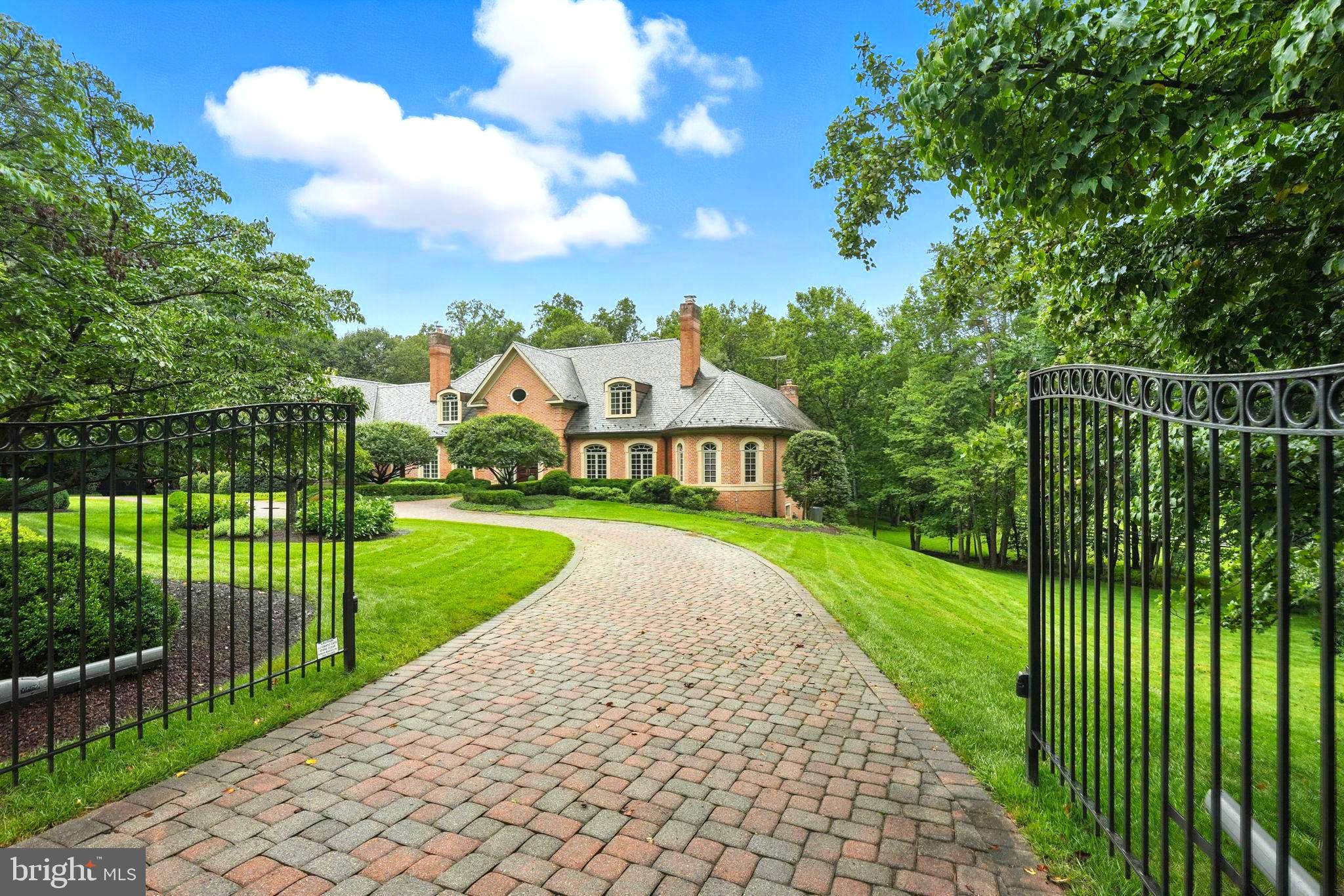 Still Available to be shown. Home sale contingency,  This is the dream....an architectural masterpiece reminiscent of an English Country Manor, offering timeless sophistication, unmatched privacy, and a premier location. The exceptional craftsmanship and impeccable finishes elevate this residence well above the ordinary.
Tucked at the end of a quiet cul-de-sac and secured behind stately gates, this private oasis is sited on a lush and manicured 3.61-acre parcel (combined lots 5&6 or 688 &684 Rossmore). A sweeping crescent-shaped cobblestone drive, slate roof, and elegant four-car side-entry garage set the stage for an unforgettable arrival.
Crafted by renowned Great Falls Construction, this one owner home is a masterclass in thoughtful design and quality. From the soaring foyer with marble and mosaic inlays, custom lighting, and graceful curved staircase, to the richly detailed formal living and dining rooms, each with fireplace and exquisite millwork, you’ll sense immediately that no expense was spared.
At the heart of the home, the Family Room rises to 20+ feet with floor-to-ceiling windows, a magnificent stone fireplace, and a full wet bar with custom cabinetry, designed for both grand-scale entertaining and relaxed evenings at home.
The newly remodeled chef’s kitchen (2025) is timeless in its elegance: crisp white cabinetry, quartz countertops, a walk-in pantry, commercial-grade stainless appliances, and generous seating options for casual or formal meals. The adjoining sun-drenched glass conservatory is the perfect place to unwind with panoramic views of rolling lawn and a neighboring equestrian estate. Step out to the tiered stone terraces, ideal for outdoor entertaining, with a graceful iron staircase connecting to the lower-level patio and screened porch. Framed by lush lawn and stately trees, the grounds provide a sweeping and versatile canvas, inviting you to bring your own vision of leisure, beauty, and recreation to life.
One of the most desirable features is the main-level primary suite, a true sanctuary with magnificent ceiling, sitting area with fireplace, and three custom closets. The spa-inspired primary bath includes a walk-in shower, dual vanities plus dedicated makeup vanity, and a luxurious Japanese soaking tub. Adjacent, is an opulent study/library, masterfully crafted in rich mahogany, featuring a warm fireplace and custom built-ins—a space that offers an ambiance that words can scarcely capture.
The main level also features two powder rooms, a spacious laundry/mudroom with exterior access, a discreet rear staircase, and a paneled elevator offering access to all three levels.
The bright, expansive walk-out lower level offers a world of possibilities. Highlights include a spacious rec room with fireplace and built-ins, a pub-style game room with wet bar, a large flexible-use space with an island ideal for crafting, homework, or home office, and several additional rooms to accommodate a gym, workshop, studio or living spaces. There’s also a full bathroom and three sizable storage/utility rooms.
Upstairs, a dramatic gallery gazes over the Family Room and grounds beyond. Three generously sized bedrooms feature ensuite baths, large closets, and rich hardwood floors. A fourth, exceptionally large suite includes a brand-new kitchenette and bath (2025), along with a bonus room/study, perfect for multi-generational living, or a nanny. Additionally, there is a walk-in cedar closet.
The estate is fenced on three sides and is clearly staked for boundary clarity on the fourth side.
All of this is located within the highly acclaimed Langley School Pyramid, and just minutes to the cultural and professional hubs of Washington, D.C., Tysons Corner, Reston Town Center, Dulles International Airport, top-tier hospitals, Great Falls Park, the Dulles Tech Corridor, churches, and the charming village center of Great Falls.
This is more than a home, it’s a lifestyle of elegance, comfort, and desirability.