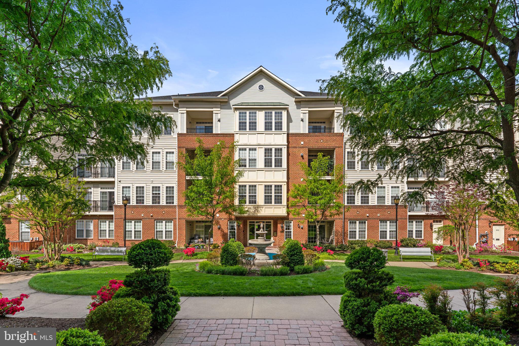Discover easy, low-maintenance living in this beautiful top-floor, three-bedroom, two-bath home located in the sought-after 55+ community of the Enclave at Ellicott Hills. Nestled in a quiet, secure elevator building, residents enjoy controlled access, a convenient mail center, a separate storage unit on the main floor, and a welcoming community gathering space.

This bright and inviting unit overlooks a serene courtyard with a fountain, best enjoyed from your own private balcony. Inside, the thoughtfully designed layout offers both comfort and functionality. A separate dining room provides the perfect setting for entertaining, while the spacious kitchen features ample cabinetry and generous counter space for effortless meal preparation. Just off the kitchen, a cozy den offers a relaxing spot to unwind.

The open living room is filled with natural light, creating a warm and airy atmosphere. The primary suite is a true retreat, complete with two large walk-in closets and an en-suite bath featuring a soaking tub, separate shower, and double vanity. Two additional bedrooms offer flexibility for guests, a home office, or hobbies.

Additional highlights include a dedicated laundry room with washer and dryer, plus extra storage space for added convenience.