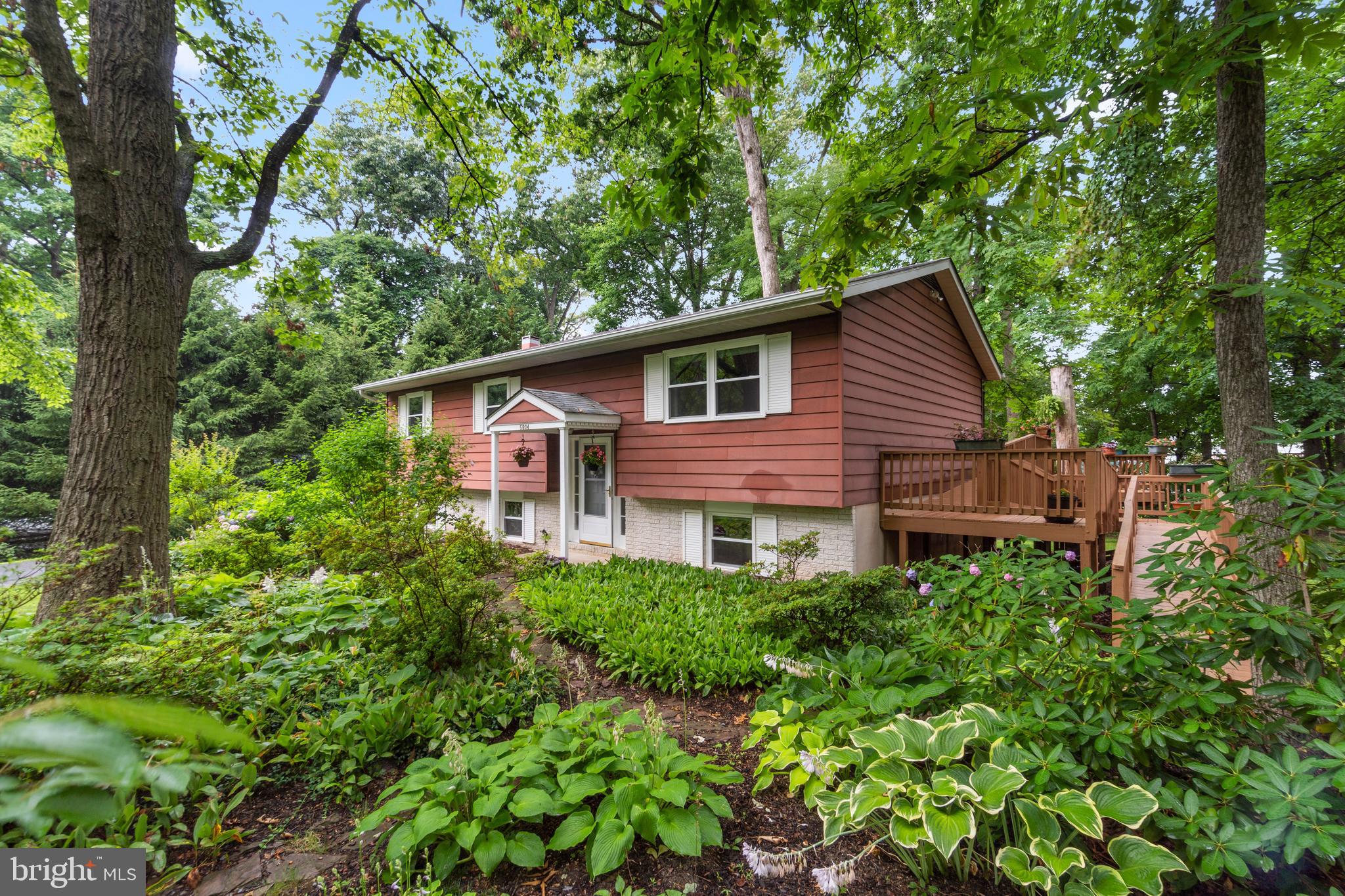 Welcome to this turn key home in Sykesville!  Welcoming split foyer on a private, wooded lot situated on a quiet street. Open concept main level with updated kitchen open to living and dining rooms. Enjoy nature on your large, tiered, wrap around rear deck perfect for entertaining or enjoying a quiet evening.  3 bedrooms on the upper level with an additional bedroom on lower level.  Primary suite offers private half bath.  Updated hall bathroom on upper level.  Spacious rec room and a large utility room complete the lower level.  Lush, mature gardens surround the house.  Close to local schools.  Schedule your private tour today.