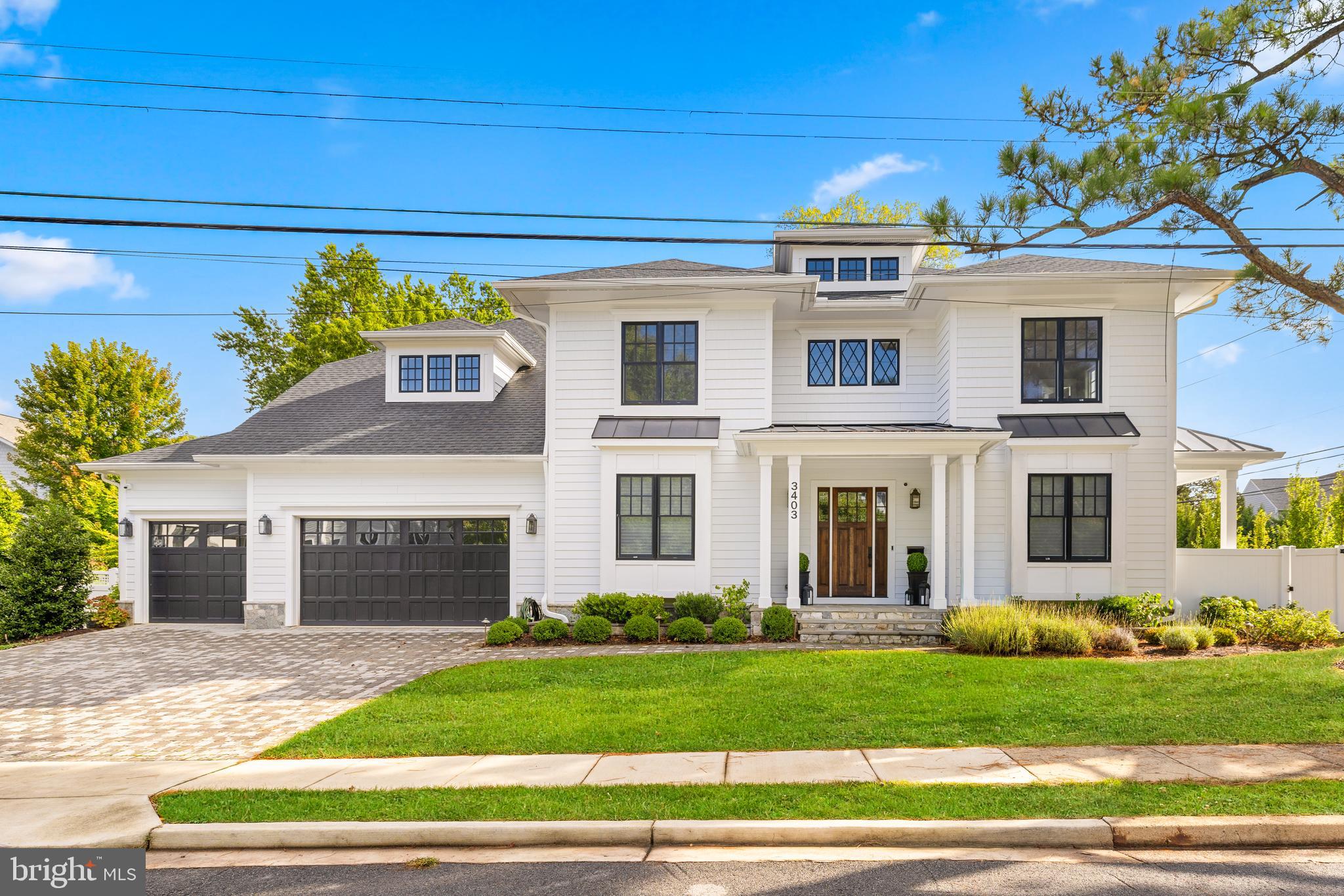 *Open Sat 1-4PM * Gorgeous, four year young  MR Custom Home beautifully-designed with luxury finishes, fixtures, hardware and tile, custom window treatments, elegant moldings, hardwood floors, a built-in speaker system, full security system, high end appliances and a whole-house generator, this is truly a special offering. This thoughtfully designed home offers three levels of light-filled living spaces, gorgeous outdoor hardscaping, mature plantings, and a three-car attached garage. Located in a highly desirable Williamsburg Village with easy access to Lee-Harrison & Chesterbrook Shopping Centers, Chestnut Hill Park and walk-able to all three top tier schools, enjoy convenience and a wonderful community at 3403 John Marshal Dr. 

Inside, the main level features ten-foot ceilings with a foyer flanked by both the dining room on one side and the living room with a porch on the other, with both rooms featuring box bay windows. There is a large family room with a coffered ceiling, a gas fireplace and a double set of 12-lite French doors that lead to the screened-in porch with an outdoor stone-surround gas fireplace, infrared heaters and built-in outdoor speakers. Opening to the family room, the gourmet kitchen features custom-designed maple inset cabinetry, double-thick quartz countertops, a large island with seating, top-tier appliances including a 48” SubZero refrigerator/freezer, a 48” Wolf gas range with 6 burners and infrared griddle, 2 Bosch dishwashers, a 30” Wolf microwave, a 48” Zephyr Siena Pro range hood, a butler's pantry with the same double-thick quartz countertops and a 36-bottle Avallon wine cooler connecting to the dining room, a pot filler faucet over the range and a breakfast nook with a built-in bench. The mudroom is accessed through the kitchen, providing cubby storage, as well as access to both the walk-in pantry and the attached three-car garage. There is also a study/fifth bedroom suite with built-ins, a walk-in closet and an en suite full bathroom, along with a powder room on this main level. 

Upstairs, the primary suite provides dual walk-in closets and a spa-like primary bath with dual vanities, a seamless glass shower, a free-standing soaking tub and a linen closet. Three additional bedroom suites, a bedroom-level laundry room and finished storage complete this level. The lower level offers an expansive recreation room with a wet bar with a beverage cooler and access to the backyard. Additionally, there is a sixth bedroom with direct access to the full bathroom, an exercise room, a theater room, a utility room and multiple storage closets. The fully-fenced backyard is lushly landscaped with mature plantings including hydrangeas, roses and lavender, as well as tall evergreens for added privacy. Both the front and backyard include an app-powered full irrigation system and night lighting to complement the landscaping. An ideal location that is a short walk to Discovery Elementary School, Williamsburg Middle School and Yorktown High School, and an easy commute to DC, Tysons and three airports.