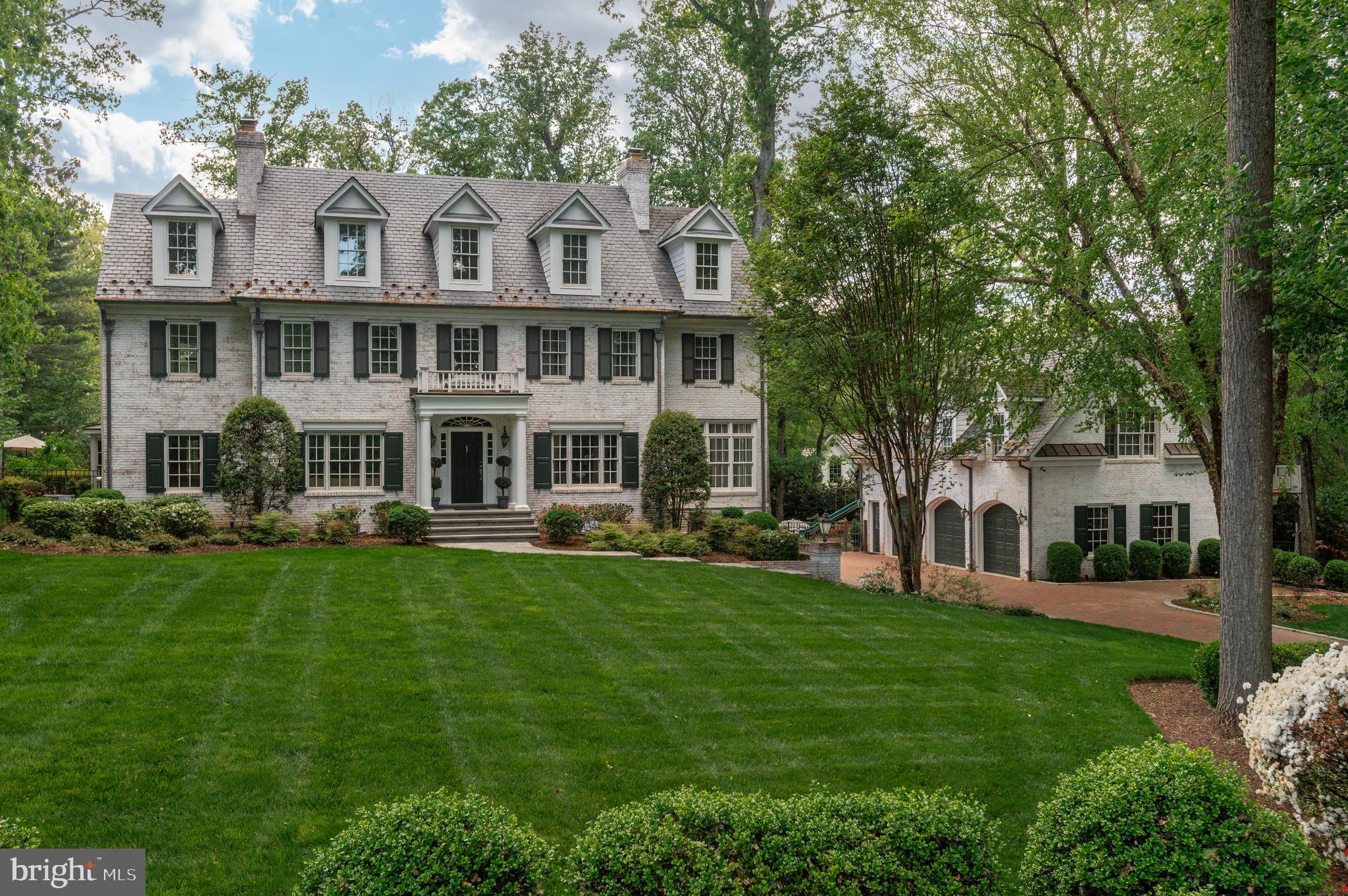 This impressive New England style estate is situated on a premium tree-lined 1-acre lot at the end of a quiet cul-de-sac in McLean. Set back from the road with a curved brick and cobblestone drive, the property features mature landscaping with year-round interest and exceptional privacy. A standout feature is the separate, fully-equipped Carriage House, which includes its own full bath and kitchenette, making it a perfect space for multi-generational living, a guest suite, a home gym, or a secluded home office.

This expansive home, with over 8,000 sq ft of living space, has four finished levels with 5 bedrooms, 6 full and 2 half baths, hardwood floors and detailed trim throughout, and includes five fireplaces that have been converted to gas. The main level features a formal living room and separate dining room, a home office and a fabulous sunroom located just off the spacious family room - with direct access to a covered deck - versatile as a playroom, library, or lounge area. The heart of the home is the spacious kitchen, with a center island and a large breakfast area, elevated by the coffered ceiling detail. From the kitchen, you can access the side porch with pergola, which makes an amazing spot for al fresco dining. The upper level has 3 ensuite bedrooms, including the spacious primary suite, with separate sitting room, two walk-in closets and a beautiful primary bath, with soaking tub and separate walk-in shower. A large laundry room, with two sets of full-size stacked washers and dryers and a half bath on the hall complete this level. The fourth-floor loft features a large open living area, a bedroom and full bath, providing an ideal space for an au pair, guests, or a quiet workspace. 

The walk-out lower level is an entertainer's dream, featuring a game room, a theater room, and a full bar with a Speakeasy Lounge area. This level also includes a prep kitchen, a full bath, a Flex Room that can easily function as an additional bedroom, craft room, or personal gym and plenty of extra storage space.

Exterior highlights include a durable Slate Roof with copper snow guards and a gorgeous flagstone terrace with a pergola. The outdoor oasis is completed by a pool with plenty of lounging areas for sun and shade seekers, a garden house, and a playground with rubber mulch ground cover, all surrounded by mature landscaping that ensures a private and exceptional space for outdoor entertaining. Langley High School pyramid. Well and septic.