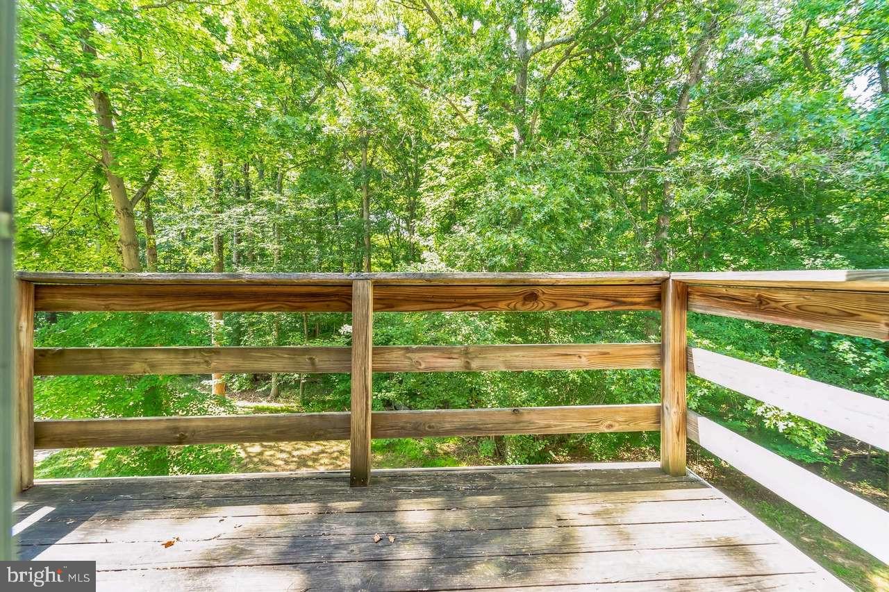 Sunny top-floor corner unit in Clary's Forest II! Maintained by one owner for 30+ years. Open-concept with cathedral ceilings, architectural volume, maximum natural light, and no upstairs neighbors. UPDATES & FEATURES: Updated (2019): Premium flooring, modern appliances, brand-new HVAC. Systems: New water heater (2024), wood fireplace, dedicated laundry room with full-size washer/dryer. Outdoor: Private balcony with scenic wooded canopy views. PRIME LOCATION: Quiet center of Columbia (21044). Walk to Howard Community College & Johns Hopkins Howard County Medical Center. 5 mins to The Mall in Columbia. Transit: Across from commuter bus (direct coach to D.C., Silver Spring, Baltimore). Quick access to Rt 29 & I-95. Adjacent to Columbia's paved path system. INVESTMENT & HOA: Rental License: Active/compliant Howard County rental license. Excellent future asset flexibility.Low-Maintenance: Condo fee covers water, trash, exterior building insurance, roofing, landscaping, and snow removal. Note: Property condition verified July 2026. Photos are  2 years old but confirmed to accurately reflect current condition.