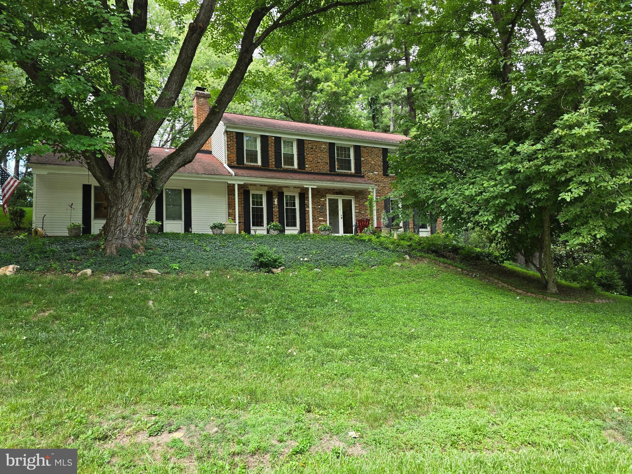 Welcome to 16601 Briardale Road, a timeless Colonial-style residence offering an exceptional blend of space, privacy, flexibility, and everyday convenience in Parkside Estates. Set on a generous corner lot with a paved driveway, mature surroundings, and a peaceful tree-lined backdrop, this home delivers the feeling of a private retreat while keeping you close to Shady Grove, commuter routes, Metro access, shopping, dining, parks, and daily essentials.

From the moment you arrive, the home offers classic curb appeal with established landscaping, mature trees, and a setting that feels both elegant and inviting. Inside, the residence features a warm and traditional layout with beautiful wood flooring throughout much of the home, spacious living areas, and a comfortable flow designed for both everyday living and entertaining.

The family room is anchored by a fireplace with gas logs, creating a cozy and refined gathering space for quiet evenings, holidays, and relaxed time at home. The dining area opens to a rear patio, offering seamless indoor-outdoor living and a lovely setting for morning coffee, summer dinners, or unwinding while overlooking the trees.

One of the most desirable features of this home is the rare main-level suite arrangement, featuring a spacious bedroom with its own separate sitting area or private living space, distinct from the main family room. This thoughtful layout creates a peaceful retreat ideal for relaxing, working from home, or accommodating a variety of lifestyle needs. A conveniently located main-level laundry room further enhances everyday functionality and ease of living.

Upstairs, four additional bedrooms provide generous space for family, guests, work-from-home needs, hobbies, or quiet retreats. The home offers room to grow, room to gather, and room to live beautifully, with each level providing flexibility for your lifestyle.

The unfinished basement adds valuable storage and future expansion potential, allowing the next owner to create the space they envision, whether a recreation room, fitness studio, media room, workshop, wine storage, or additional finished living area. An exterior entrance provides added convenience and flexibility, enhancing accessibility and expanding future possibilities for the lower level.

Outside, the corner lot, paved driveway, and wooded rear setting create a wonderful sense of privacy rarely found so close to major conveniences. Ideally positioned near Shady Grove Metro, I-270, ICC/MD-200, parks, shopping, dining, and the many amenities of Rockville, Derwood, King Farm, and the surrounding area, this home offers the best of both worlds: peaceful residential living with outstanding access to everything you need.

Schedule your private showing today and experience the space, privacy, and convenience that make 16601 Briardale Road such a special Rockville offering.