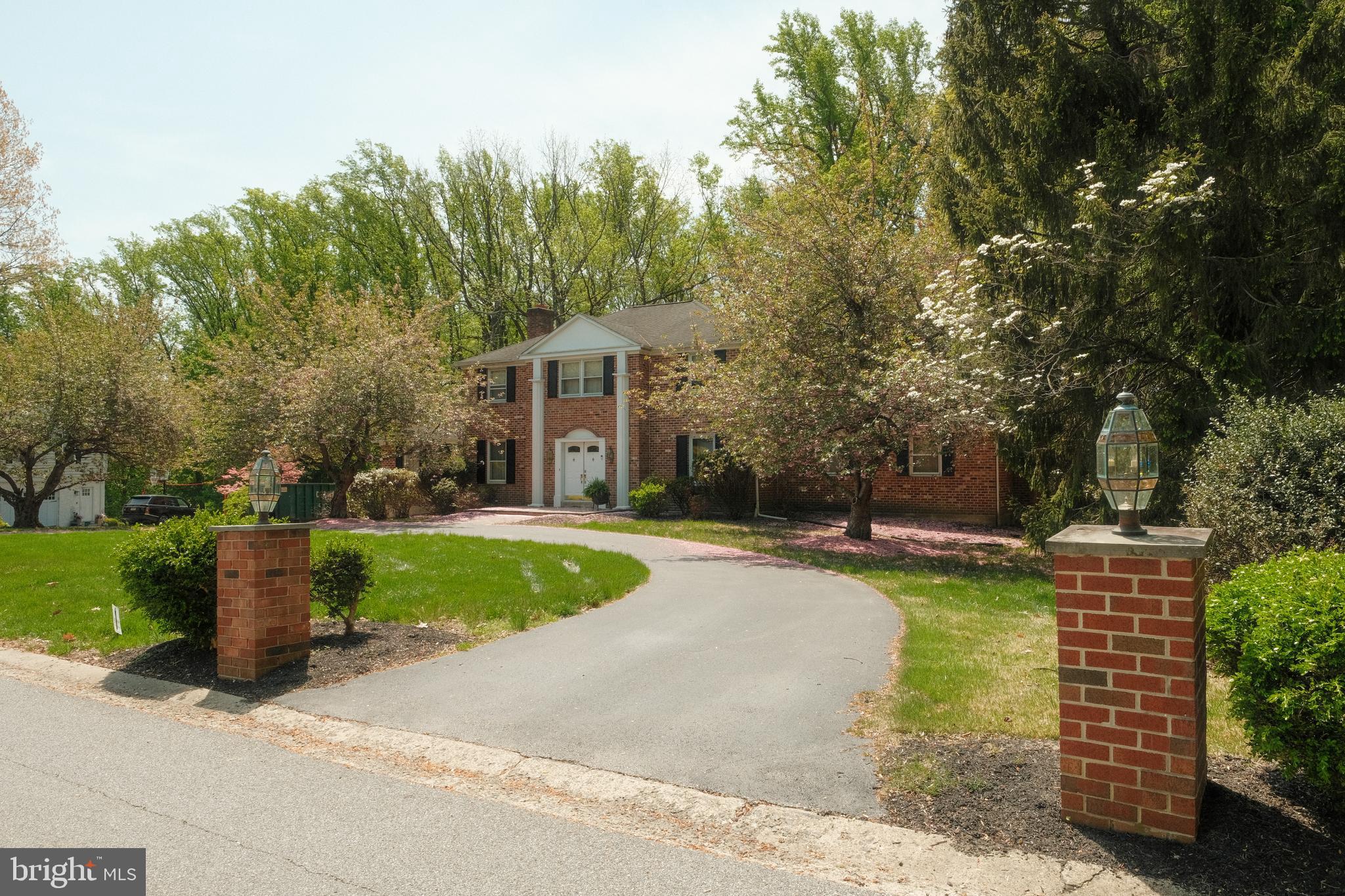Solid brick colonial, set on a park-like acre with a circular driveway and 2‑car side‑load garage,  The large entrance foyer includes multiple closets and leads to the step down formal living room with a gas fireplace and wall‑to‑wall carpeting, with what appears to be original hardwood flooring underneath. French doors open to the formal dining room, which connects to an expansive kitchen featuring a wet bar, beverage area, and an oversized breakfast room with access to the tiered rear deck. A vaulted great room with exposed beams and a gas fireplace sits just off the kitchen, along with a study accessed by French doors. The first floor also includes a powder room, a mud room with access to the garage, and a laundry room. Upstairs, the primary bedroom offers ample closet space and a full bath, while three additional bedrooms—all with double closets and wall‑to‑wall carpeting with what appears to be original hardwood flooring underneath—share a hall bath and linen closet. The walk‑out lower level includes a bar area, wine cellar, gas brick fireplace, powder room, sliders to the rear yard, additional exterior‑access storage through double doors. The home is solid and in need of cosmetic updating.  This location  provides convenient access to major arteries, the train, downtown Media, and is under 20 minutes to PHL International Airport.
Inspections are welcome, any findings are the Buyers responsibility. Buyer responsible for U & O