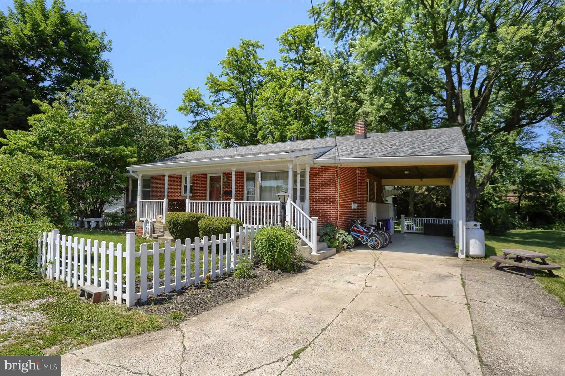 This charming brick ranch home offers 2 bedrooms, 2 full bathrooms, hardwood floors and a classic, comfortable layout. The kitchen features skylights, a pantry, all appliances included and a double oven that's ready for holiday baking or entertaining. The inviting living room features a cozy propane gas fireplace. The centrally located main-floor laundry room serves as a convenient household hub with washer and dryer included, plus generous shelving and storage space for small appliances, pantry overflow and everyday essentials. The partially finished lower level expands the living space with a family room, bonus room and additional flex space for hobbies, storage or even a home office. Outside, you'll find a welcoming covered front porch, carport, off-street parking, shed, pond and a nice level backyard that offers plenty of space for gardening, pets or simply enjoying the outdoors. The home has an electric heat pump with central air as well as a mini-split system serving the lower level. Public water and sewer complete the package. Affordable, comfortable and full of potential, this one is priced to move!