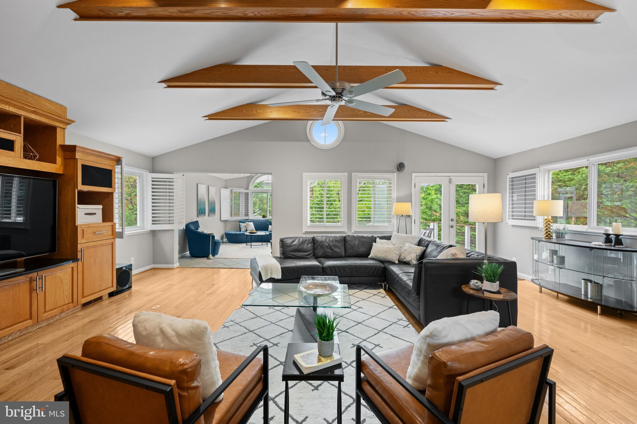 Defined by its dramatic cathedral-ceiling family room and treehouse-like deck overlooking the surrounding canopy, this exceptional North Cleveland Park residence offers a rare combination of scale, flexibility, and walkable urban convenience. Thoughtfully designed for both grand entertaining and comfortable daily living, the home features 5 bedrooms, 3.5 baths, across 5 finished levels of almost 5,000 square feet of beautifully proportioned living space.

At the heart of the home, the stunning family room is anchored by custom built-ins, a wet bar, and walls of glass opening to the expansive rear deck, creating a seamless indoor-outdoor living experience. A gracious living room, formal dining room, and spacious eat-in kitchen provide exceptional flow throughout the main level, making the home equally suited for intimate gatherings and large-scale entertaining.

The upper level is highlighted by an extraordinary primary suite with dual walk-in closets, an additional storage closet, adjoining office, and spa-inspired bath with a glass-enclosed dual-head shower and jetted tub. Four additional bedrooms provide ample accommodations, while the lower level offers exceptional versatility with an au pair suite, recreation room, exercise room, office, and extensive storage rarely found in Washington homes. Additional highlights include an attached garage with EV charger, private deck with built-in TV, underground sprinkler system, mature landscaping, and a custom Birds of Paradise mosaic window welcoming guests at the front door.

Ideally located just blocks from the Van Ness Metro, Giant, Mom's Organic Market, Calvert Woodley, neighborhood restaurants, farmers markets, parks, playgrounds, tennis courts, and highly regarded public and private schools, the home also benefits from its proximity to Washington's embassy district. A rare opportunity to enjoy substantial living space, exceptional entertaining areas, and one of Upper Northwest's most desirable and convenient locations.  Please note: Square footage is estimated and calculated by an independent third party; information is deemed accurate but not guaranteed.