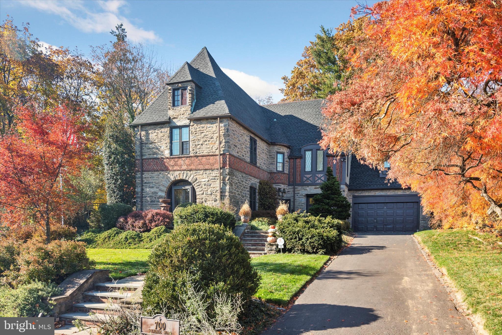 Nestled in the prestigious enclave of Baederwood, Abington Township, 700 Wyndale Road presents a captivating blend of timeless elegance and modern comfort. This Stone Tudor home boasts 5 bedrooms, 4.5 bathrooms, and a generous 3733 square feet of living space on a sprawling 14040 square foot lot. Upon entering, the grandeur of the formal living room, adorned with a wood-burning fireplace, sets the tone for sophisticated gatherings. The adjacent formal dining room exudes an air of refined charm, while the gourmet kitchen, a haven for culinary enthusiasts, is equipped with top-of-the-line appliances and stylish finishes. A private study on the main floor offers a secluded space for productivity and contemplation. Upstairs, the primary bedroom exudes a bright and cheery ambiance, complemented by an adjacent bathroom that can only be described as fantastic. Three additional inviting bedrooms and a well-appointed bathroom complete the second floor. The lower level unveils a full basement, complete with a workshop, laundry facilities, and a gentleman's tasting lounge, providing ample space for leisure and productivity. Outdoors, the enchanting landscaping reminiscent of Covent Gardens outside London sets the stage for al fresco entertaining. An outdoor kitchen beckons gatherings, while a serene coy pond adds a touch of tranquility to the expansive grounds. With air conditioning, a basement, and the allure of Tudor architecture, this home seamlessly combines classic allure with modern amenities, promising a lifestyle of unparalleled luxury. Experience the epitome of gracious living at 700 Wyndale Road. ALL OFFERS ARE DUE MONDAY AT NOON!