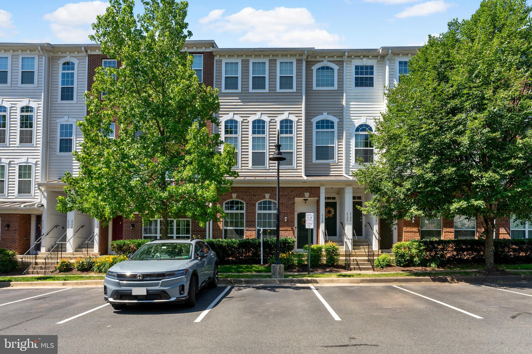 Welcome To The Market Center Community, Where Comfort, Style, & Convenience Come Together! This Beautifully Maintained 2-Level Condo Townhome With A 1-Car Garage With Storage, And Plenty Of Unassigned Parking, Offers Thoughtfully Upgraded Living Spaces Throughout. Enjoy Your Morning Coffee From The Charming Front Porch Before Stepping Inside To An Inviting Foyer That Leads Into The Stunning Main Living Area. The Main Level Showcases Engineered Hardwood Flooring Throughout & A Spacious Family Room Featuring Dramatic Two-Story Ceilings, Oversized Windows That Fill The Space With Natural Light, A Cozy Gas Fireplace, & A Overhead Ceiling Fan With Lighting. The Open-Concept Layout Flows Seamlessly Into The Kitchen & Dining Area-Perfect For Everyday Living & Entertaining. The Upgraded Kitchen Is Sure To Impress With Granite Countertops, Stylish Backsplash, Upgraded Soft-Close Cabinetry & Drawers, Pantry Storage, Recessed Lighting, Stainless Steel Appliances, Gas Cooking, Under-Cabinet Lighting, & A Large Center Island With Pendant Lighting & Additional Seating Space. A Convenient Powder Room & Interior Garage Access Complete The Main Level. Upstairs, Retreat To The Spacious Primary Suite Featuring Engineered Hardwood Flooring, A Ceiling Fan With Lighting, Private Balcony With Additional Storage, A Walk In Closet With A Beautiful Barn Door, & A Luxurious En-Suite Bathroom. The Primary Bath Offers A Dual Sink Vanity, Relaxing Soaking Tub Highlighted By A Chandelier, Separate Shower, & Charming Barn Door Entry. The Second Bedroom Also Features Engineered Hardwood Flooring, A Ceiling Fan With Lighting, Closet Organizer System & A Barn Door Closet. An Additional Full Bathroom Includes An Upgraded Vanity & Shower/Tub Combination. The Upper-Level Laundry Room Adds Everyday Convenience With A Washer, Dryer, & Built-In Cabinetry For Extra Storage. Enjoy All That The  Community Has To Offer, Including A Fenced In-Ground Pool, Playground, And Tennis Courts. The Condo Fee Includes Water, Trash, Exterior Building Maintenance, & Snow Removal, Allowing For Easy, Low Maintenance Living. Ideally Located Near I-66, UVA Health Haymarket Hospital, Charming Downtown Haymarket Shops & Restaurants, Grocery Stores, Wineries, & More-This Home Offers The Perfect Blend Of Modern Updates, Amenities, & An Unbeatable Location. Don't Miss Your Opportunity To Call This One Home!