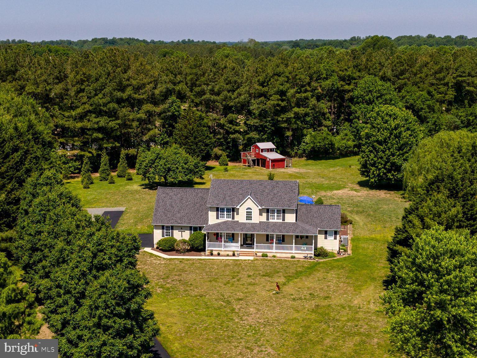 Situated at the end of a cul-de-sac in Cordova, this well-maintained home offers 3.7± acres surrounded by mature trees with convenient access to Route 50, Easton, Wye Mills, and nearby amenities. A covered front porch welcomes you inside to a thoughtfully designed layout featuring hardwood flooring throughout most of the home, four bedrooms, and two-and-a-half bathrooms. The main level includes a desirable primary suite, formal dining room, and a flexible room off the foyer currently used as a gym that could easily serve as a home office. The kitchen is centered around a large island and opens to the living spaces, creating an ideal setup for both everyday living and entertaining. Pride of ownership shines through with substantial recent updates to the home’s interior, appliances, mechanical systems, and outdoor features. Upstairs, two bonus rooms provide additional versatility for office, study, hobby, or guest space. Outdoor features include a deck with pergola overlooking the inground pool, a two-car garage, storage shed, and additional stall barn, offering plenty of room for equipment, hobbies, or animals. This property combines space, functionality, and a convenient Eastern Shore location.