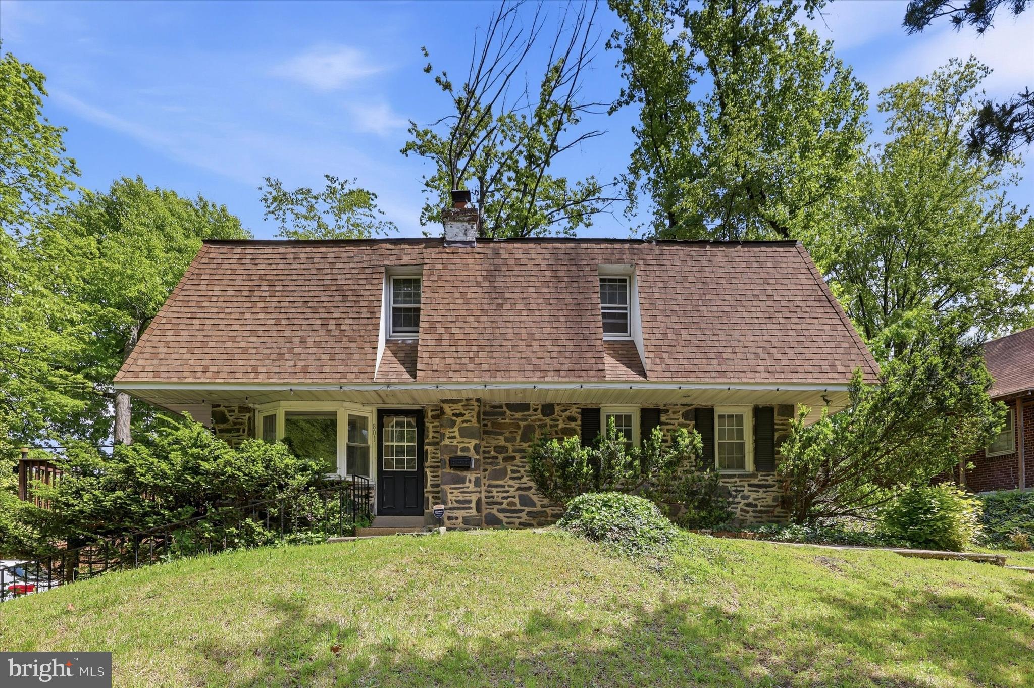 Welcome to this one-of-a-kind stone Cape Cod where classic charm meets unexpected space and character. Nestled on a beautiful lot surrounded by mature trees, this home offers the perfect blend of warmth, personality, and flexibility.  Step inside to find a cozy yet open main level featuring hardwood accents, abundant natural light, and two spacious bedrooms with a full bath. The spiral staircase creates a striking focal point and leads to the show-stopping upper level — an enormous loft-style primary retreat complete with soaring ceilings, exposed beams, skylights, and a private en suite bathroom. Whether you envision a luxurious owner’s suite, creative studio, reading lounge, or all of the above, this space delivers endless possibilities and a true getaway feel right at home.  Out back, escape into your own peaceful retreat. The wraparound deck extends from the side of the home into a secluded backyard oasis, creating the perfect setting for morning coffee, entertaining friends, summer BBQs, or simply unwinding in nature.  Need even more space? The basement already includes a full bathroom and bonus room just waiting for your finishing touches — ideal for a future guest suite, home office, gym, media room, or additional living area.  With its distinctive architecture, oversized loft suite, private outdoor setting, and incredible potential, this home is anything but cookie cutter. A rare opportunity to own a Cape Cod with character, flexibility, and space that truly stands out from the crowd.