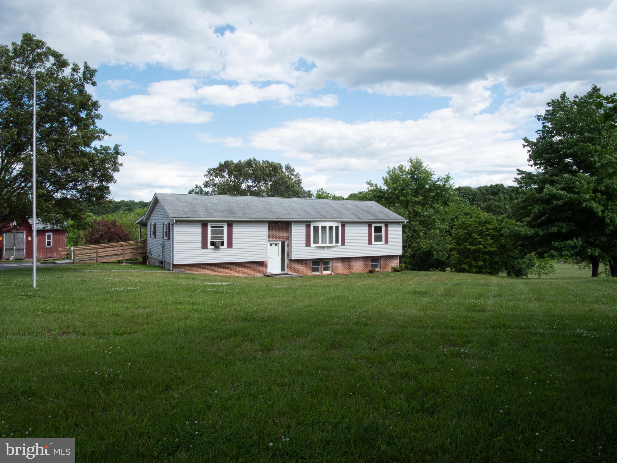 COUNTRY LIVING  ON SPRAWLING 2.41 ACRE FARMETTE THAT IS LESS THAN 1/2 MILE TO MARYLAND LINE. BUILT IN 1988, NOT 1960 AS IN TAX RECORD!! LARGE, PRIVATE, COVERED BACK DEK  IS WAITING FOR YOU TO ENJOY THE STUNNING VIEWS OF PARK-LIKE GROUNDS, TREE-LINE, WILDLIFE (DEER, HUMMINGBIRDS, OCCASIONAL EAGLES) & FARM THAT DATES BACK TO 1700S. SPACIOUS SPLIT FOYER BUILT IN 1988 . MOVE IN AND ADD YOUR FINISHING TOUCHES. LARGE EAT-IN KITCHEN WITH WOOD FLOOR & PANTRY HAS SPACE FOR KITCHEN TABLE. PRIMARY BEDROOM SUITE HAS FULL BATH WITH SOAKING TUB/SHOWER COMBO. 2ND  FULL HALL BATH ON MAIN LEVEL. WALK-OUT LOWER LEVEL HAS:  HUGE L-SHAPED RECREATION ROOM WITH SLIDERS TO COVERED PATIO & BACK YARD; BONUS ROOM WITH EGRESS WINDOW & WALK-IN CLOSET; 1/2 BATH WITH ROUGH-IN FOR SHOWER; AND LAUNDRY/STORAGE/UTILITY ROOM  WITH 1-ZONE MINI SPLIT SUPPLIED AND TO BE INSTALLED BY BUYER.  NEW SEPTIC TANKS 2021. BRAND NEW GOULD WELL PUMP. WITH 5 YR. WARRANTY.  2021 RANGE, REFRIGERATOR, BUILT-IN MICROWAVE & WATER HEATER.  RECENT MAYTAG WASHER & DRYER. .9 MI. FROM SHEPPARD MEYERS RESERVOIR/LONG ARM DAM FOR FISHING & BOATING WITH ELECTRIC MOTOR. 6 MINUTES TO SHOPPING AND DINING  IN SOUTH HANOVER. 15-20 MINUTES TO ADDITIONAL SHOPPING, DINING, HOSPITAL IN NORTH HANOVER AS WELL AS WESTMINSTER, MD. COMMUTING DISTANCE TO BALTIMORE & FREDERICK, MD AND GETTYSBURG, YORK, HARRISBURG, PA.