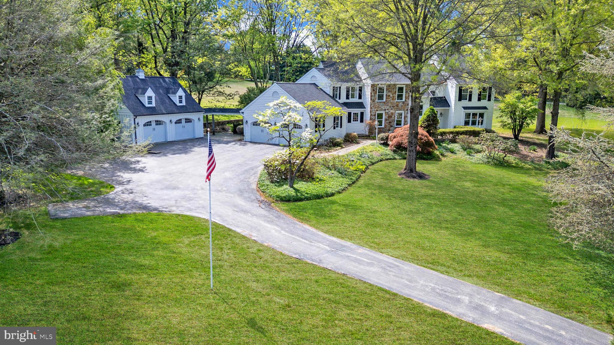 Welcome to 701 Haldane Drive, a beautifully renovated custom home set on 3.3 scenic acres in the award-winning Unionville-Chadds Ford School District, tucked within the exclusive 11-home Haldane community just minutes from Kennett Square, West Chester, and Longwood Gardens. This exceptional 4-bedroom, 2.5-bath residence blends timeless Chester County character with extensive recent upgrades including a brand-new gourmet kitchen, newly remodeled bathrooms, new septic system, new roof , and fresh interior and exterior paint. A dramatic cathedral two-story foyer welcomes you inside, where freshly refinished hardwood floors span the main level. The impressive great room features exposed beam detail, recessed lighting, ceiling fan, large panoramic windows, and a striking stone fireplace with gas insert and wood mantel, while the formal living room offers a brick gas fireplace and the elegant dining room showcases crown molding and classic wainscoting. The completely renovated gourmet kitchen is a standout with brand new GE Café appliances, six-burner gas cooktop with vented hood, double wall ovens, built-in microwave, quartz countertops, tile backsplash, deep sink, new cabinets with soft-close cabinetry, pantry, breakfast area, and bar space, and opens seamlessly to a tiled mudroom with built-ins, spacious laundry room with sink and included front-load washer and dryer, and a bright sunroom leading to the bluestone patio for ideal indoor-outdoor living. A private main-level office with floor-to-ceiling built-ins adds flexibility for today’s lifestyle, while upstairs a turned staircase with oak treads and painted risers leads to a loft overlooking the foyer and great room and a spacious primary suite featuring hardwood floors, crown molding, walk-in closet with custom shelving, and a luxurious bath with soaking tub, oversized glass-enclosed tile shower, and quartz vanity tops, complemented by three additional generously sized bedrooms and a brand new hall bath with tile surround tub/shower and quartz double vanity. Additional highlights include a perimeter basement waterproofing system, attached two-car garage plus a detached two-car carriage house with loft storage and new board-and-batten siding, and a beautiful slate courtyard with retaining wall—all set in one of Chester County’s most desirable and convenient locations.
