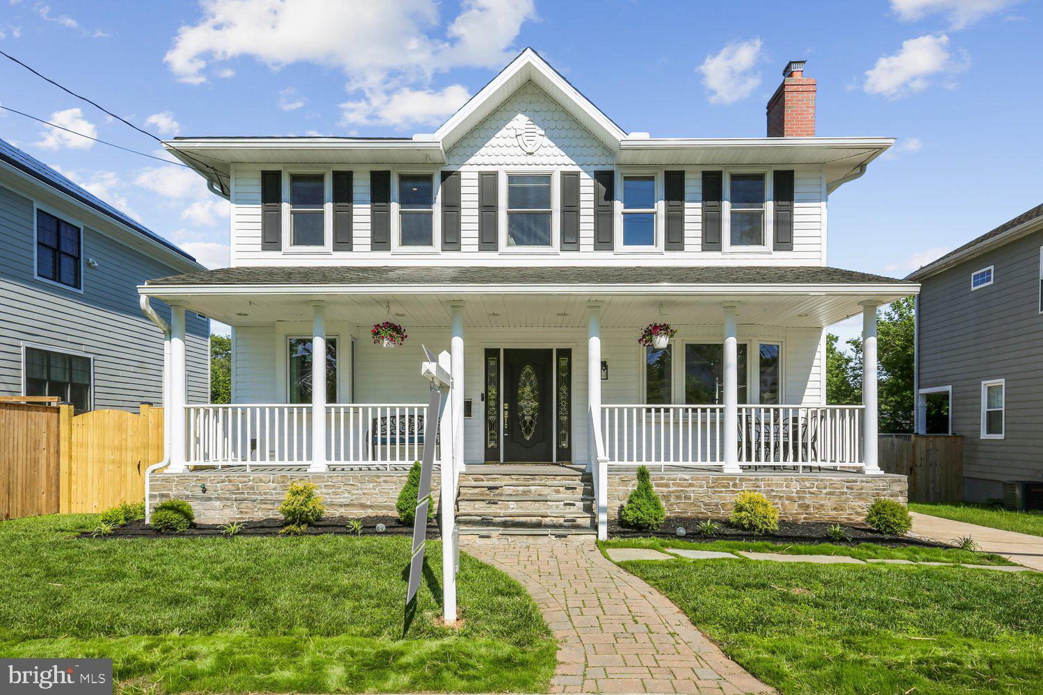 Storybook transformation into a bright and open 4BR/4.5BA three-level colonial with an old-fashioned front porch and off-street parking in Georgetown Village, just one block from the elementary school. Following expansions and renovations in 2022 and 2026, the home nearly doubled in size, now offering over 4,800 square feet of living space across three levels, including a lower-level in-law/au pair suite. Fine craftsmanship, unique design, and quality materials define this showpiece home, highlighted by an expansive kitchen/dining/great room; newly refinished hardwood flooring throughout the main and upper levels; fully renovated bathrooms with designer porcelain and ceramic tile; custom painting; upgraded and recessed lighting; new designer carpeting and LVP flooring on the lower level. Andersen windows, along with a newer roof and siding, add lasting value. The outdoor space is equally impressive, featuring professional landscaping with manicured beds, a newly fenced yard, a newly constructed TimberTech deck with wrought iron railings, and a private sunken patio with access to a storage room.  Cobblestone paver walkway and flagstone steps lead to the covered front porch with composite decking, beaded ceiling, vinyl railings, and recessed lighting.  Glass front door with side transoms opens into the foyer and living room, which features a wood-burning fireplace and a bay window. Flexible study or dining room with glass French doors opens to a hallway with a separate exterior side entrance and a corridor to the kitchen. The open-concept chef’s kitchen features self-closing white Shaker-style cabinetry with pull-out drawers, quartz countertops, a tumbled tile backsplash, a porcelain farmhouse sink with a box window ledge, champagne-bronze fixtures, upgraded appliances, a commercial-range hood, and ample pantry space. The center island with a quartz waterfall edge and cage lighting opens to the informal dining area and great room, featuring abundant windows, rear double French doors to the deck, a built-in linear electric fireplace, and custom bookshelves. Renovated powder room completes the main level.  Solid-wood staircase with a carpet runner leads upstairs to a hallway with a designer chandelier, recessed lighting, and a linen closet. The open loft area—ideal for a playroom, exercise space, or media room—features a glass sliding barn door to the laundry room. The primary suite offers recessed lighting, a ceiling fan, a separate sitting area with a linear electric fireplace, and a custom walk-in closet with built-ins. The renovated primary bath includes large-format porcelain tile flooring, a double vanity with a marble top, a separate water closet, and an oversized walk-in shower with a frameless glass enclosure. Two additional bedrooms with ceiling fans and recessed lighting, along with a remodeled hall bath featuring tile flooring, a granite vanity, and a porcelain-tile tub surround, finish the upper level.  The walk-out lower level includes a recreation room with new carpeting, built-in bookshelves, and a full bath. A step-down leads to the private in-law/au pair suite with its own glass-door side entrance, LVP flooring, second laundry hookup, bedroom with a walk-in closet, and a full porcelain-tile bath with a zero-entry, curbless shower. The suite’s full daylight living area includes recessed lighting, a linear electric fireplace, a full kitchen, and French doors opening to the sunken concrete patio with the deck above. A storage room is accessible from the patio. Three zones of heating and cooling (2018 and 2022), along with newer roof, siding, and gutters (2022), complete this exceptional offering.