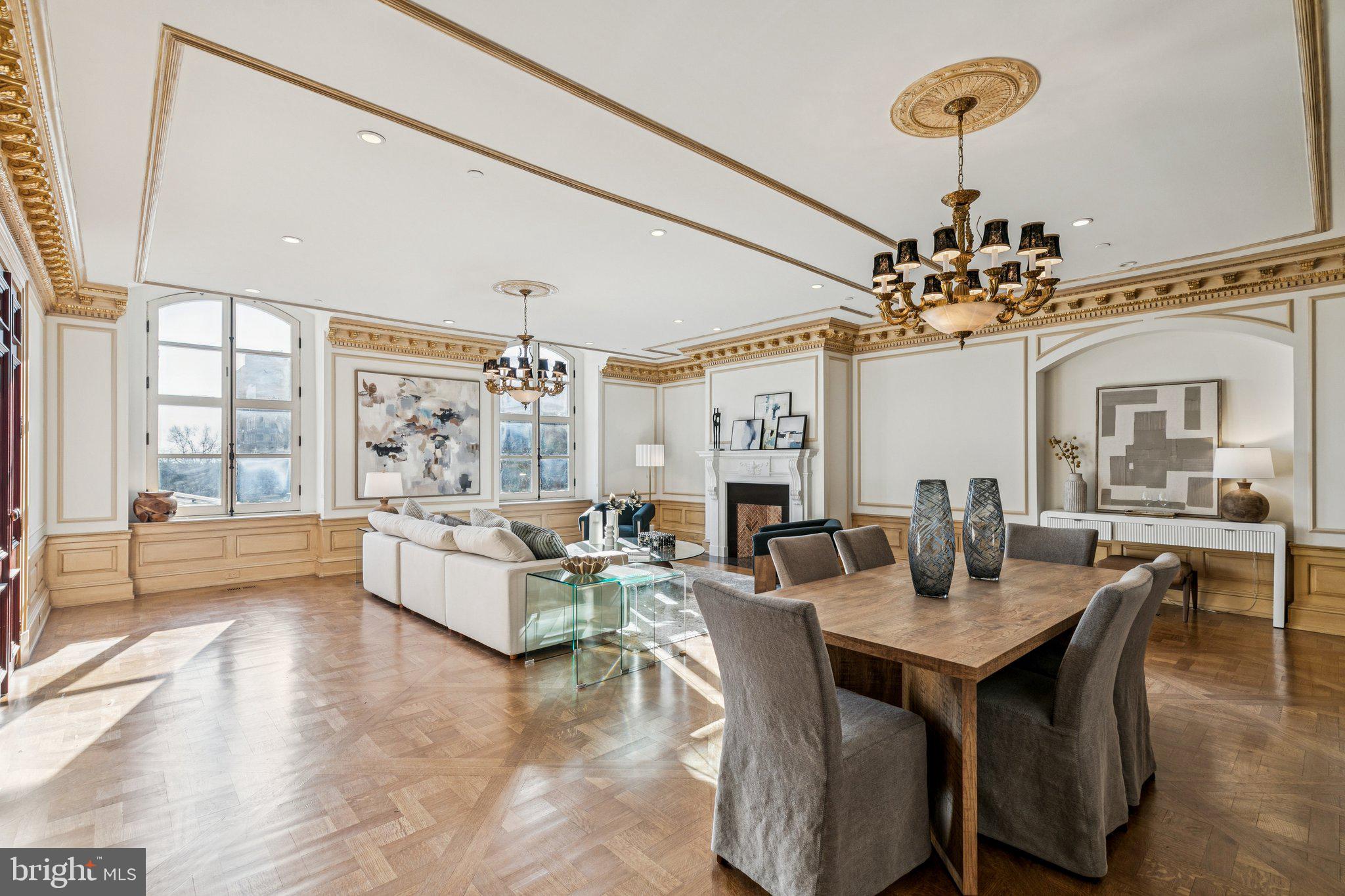 Spectacular residence boasting incredible architectural details and modern updates at The Bank Building in the heart of historic Philadelphia. This grand home, nestled between the desirable neighborhoods of Society Hill and Old City, features three bedrooms, two and a half bathrooms, high ceilings, gorgeous architectural details and craftsmanship, oversized windows showcasing southern views, and incredible entertaining space. Enter through a wooden double door into the breathtaking, marble-appointed center gallery boasting Carrara and Bardiglio flooring, a coffered Venetian plaster ceiling accented with authentic gold leaf, custom marble trim and moldings, and space for a den/study. The expansive, open great room offers Versailles-pattern oak flooring, oversized soundproof windows providing beautiful natural light and views of historic landmarks including the Second Bank of the United States, a decorative fireplace with custom mantle, wainscotting, intricate golden trim, an open formal dining area with room to fit a 10+ person table, and ample space for everyday living and entertaining. Designed by Joanne Hudson, the custom kitchen is a chef's dream! It features Downsview wood cabinetry, solid stone countertops, designer tile backsplash, massive sink with garbage disposal, large center island with butcher block countertop and breakfast bar, and a high-end appliance package including a Wolf oven and six burner gas range with hood, paneled Sub Zero refrigerator with two freezer drawers, paneled Bosch dishwasher, and Thermador microwave. Off of the kitchen is a separate laundry room with built-in cabinetry and Miele washer/dryer, as well as a conveniently located powder room. On the other end of the center gallery are all of the bedrooms, allowing for better privacy and quiet. The luxurious primary suite is showered in light from more oversized windows and enjoys wood flooring, a large seating area, walk-in closet with custom built-ins, and a spa-like ensuite bathroom. The lavish bathroom appointed in limestone boasts designer tilework throughout, a double vanity, whirlpool soaking tub, water closet, and glass enclosed walk-in shower with eight shower heads. There are two additional generously sized bedrooms with large windows and excellent closet space that enjoy use of a full hall bathroom featuring a large vanity with built-in storage and tub shower with custom tilework. Additional home highlights include stunning millwork and trim, recessed lighting and custom light fixtures, solid wood doors, and fresh paint throughout. The Bank Building is a boutique condominium building in the heart of historic Philadelphia. Residents enjoy a doorman, concierge, and access to the adjoining Renaissance Hotel's amenities, including the state-of-the-art fitness center and pool, and for an additional fee, room service, housekeeping, and valet parking in the Bourse Garage. Walking distance to Independence Square, historic sites, gardens, museums, world-class dining, retail, and cultural institutions. Easy access to 30th Street Station, I-95, I-76, Ben Franklin Bridge, and the Philadelphia airport.
