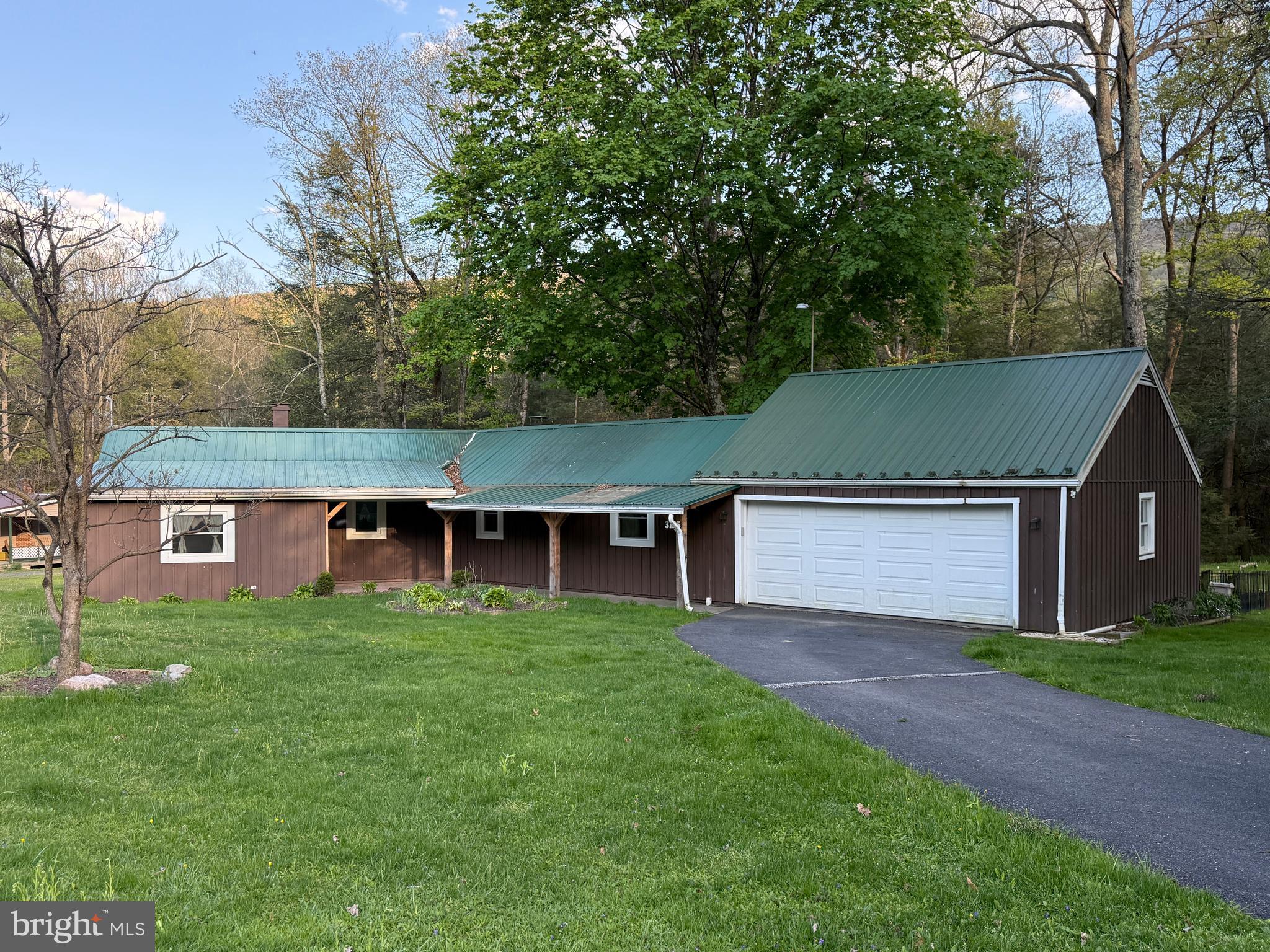 Cozy home nestled in New Lancaster Valley! This home has replacement windows/exterior doors, an Amish built covered walkway to the front door and an Amish built rear deck. The interior and exterior have been meticulously maintained. When you enter this home, you walk into a 8x15 sitting area that opens into the dining and kitchen area. The dining room has a propane wall heater as one of the three sources of heat in the home. From the kitchen you can enter either the family room or bedrooms. The large family room is 21x20 and features a pellet stove and access to the rear deck and rear patio areas. The laundry is situated between the kitchen and family room. There are two bedrooms and a full bathroom with an additional bathroom that could be either a bathroom or storage area. The property has onsite well and septic. The attached garage is 24x24 with a paved driveway with room for many additional vehicles. This could be a great home or a weekend getaway!
