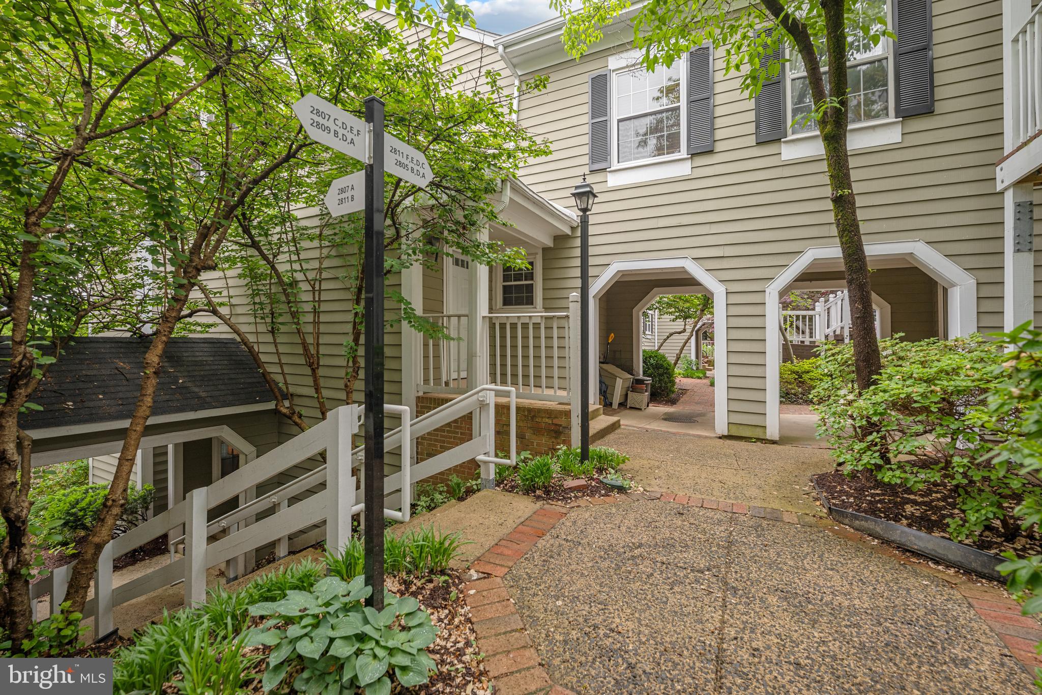 Welcome home to Courtbridge, a sought-after community nestled in the heart of Shirlington. Updated throughout with modern finishes and thoughtfully designed for comfortable living, this condo is truly move-in ready. A convenient pass-through connects the sunny dining room to the kitchen, where stainless steel appliances and sleek granite countertops await. Anchoring the main living space, a sunken living room features a cozy wood-burning fireplace and generous windows that flood the space with natural light, with direct access to a peaceful covered balcony surrounded by mature trees for both privacy and shade. The generously sized primary suite features a private sitting area, plush carpeting, and a large walk-in closet with a custom closet system - complemented by an en suite bath with a handsome vanity and modern finishes. Situated just off the living room, the second bedroom is ideal as a home office, guest room, or whatever suits your needs - with a second full bath nearby creating a flexible and comfortable arrangement for guests or roommates. In-unit laundry rounds out this beautifully updated home. This popular community offers two parking permits and an outdoor pool to enjoy all Summer long! Just minutes to Harris Teeter, the Village at Shirlington, Shirlington Dog Park, Four Mile Run Park and Trail, Old Town Alexandria, Mark Center, Amazon HQ2, and The Pentagon. Quick access to I-395, I-495, Route 7, Columbia Pike, Glebe Road, and Route 66, with easy reach to Reagan National Airport. Don't miss your chance to call Courtbridge home - schedule your showing today!