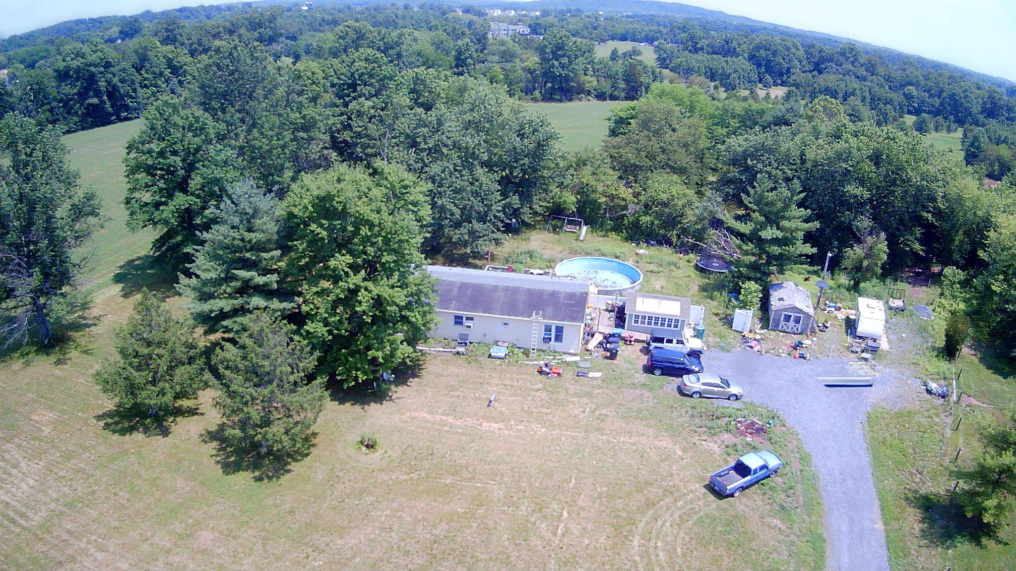 Some properties are defined by the home; this one is defined by the land. Rarely available in Douglass Township, this approximately 9.7-acre property offers usable land, approximately 605 feet of road frontage, and a unique opportunity for those seeking privacy, investment potential, or future possibilities. The existing residence requires substantial rehabilitation and is being offered as an exceptional opportunity for renovation, replacement, or exploration of the property's potential.  This unique property presents exceptional possibilities for a variety of buyers and is being sold as-is.
According to discussions with the township, the property may offer subdivision potential. Buyers are responsible for conducting their own due diligence regarding zoning, subdivision approvals, and development possibilities.
Whether you're looking to create a private estate, renovate the existing home, build your dream home, or explore future investment opportunities, properties offering this combination of acreage, frontage, and location rarely become available.
Conveniently located near Routes 100 and 73 with easy access to shopping, schools, and commuting.