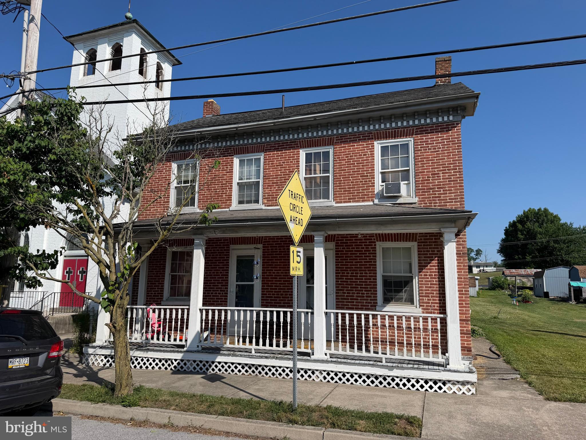 Here's an honest opportunity in Jefferson Borough, a quiet little town surrounded by the farmland and rolling countryside of southwestern York County. This two-story brick home needs work and is being sold as-is. For the right buyer, the pieces are here. The brick exterior and covered front porch give you a solid starting point, and the real value-add may be out back: multiple outbuildings including a unique summer kitchen, a larger workshop-style structure, and a covered carport — offering storage, hobby space, or project potential that's hard to find at this price point. Whether you're an investor looking at the numbers or a handy owner-occupant willing to put in the effort, the gap between purchase price and finished value is where your equity gets built. Seller will make no repairs; property conveys in present condition. Walk it, run your numbers, and decide for yourself!