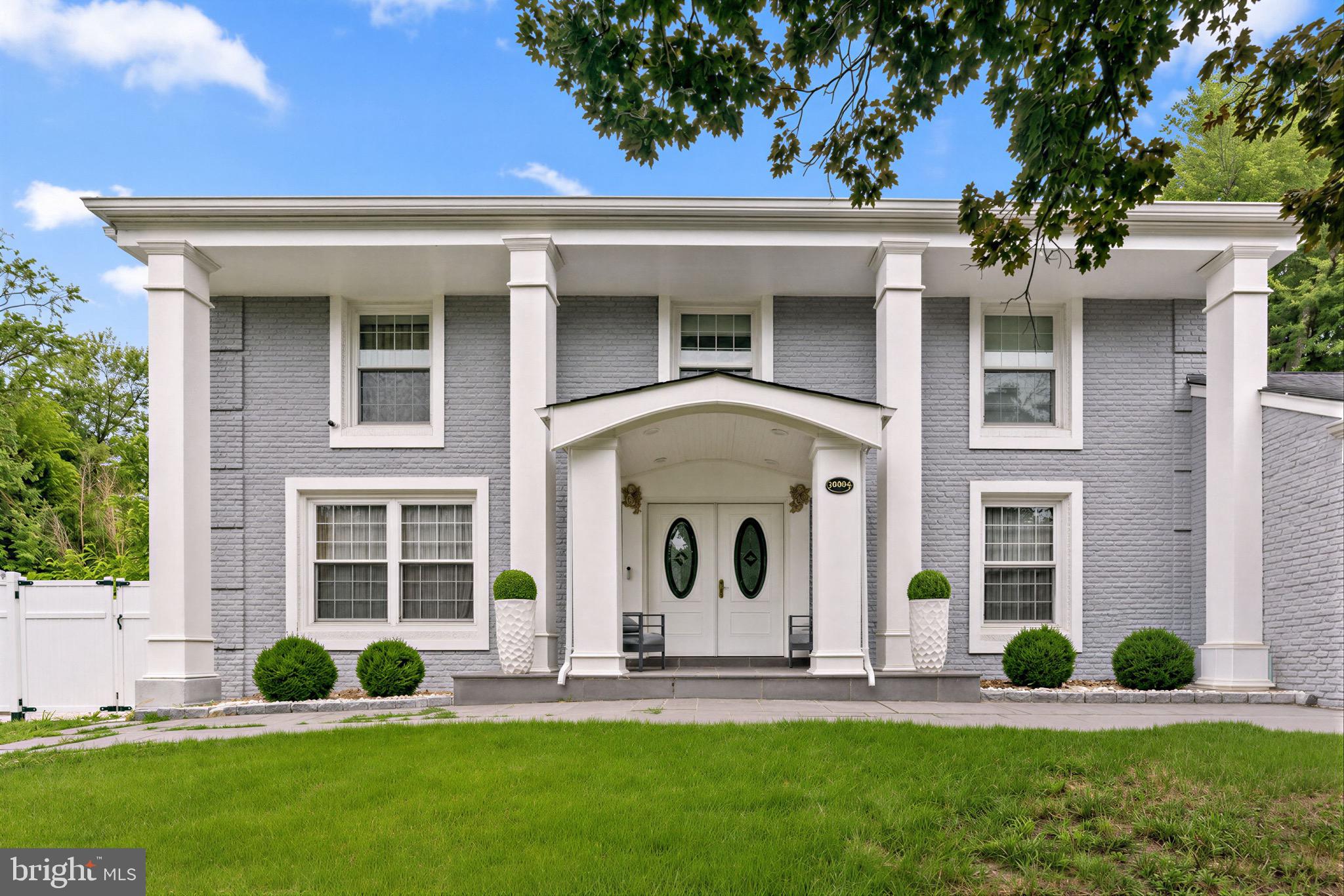 Tucked into one of Potomac's most established neighborhoods, this stunning brick Colonial has been completely reimagined, blending timeless architecture with the comfort, efficiency, and style of a modern luxury home. Offering approximately 3,500 square feet across three finished levels, this move-in ready residence features four bedrooms, three and a half baths, and extensive top-to-bottom renovations throughout. Beyond the beautiful finishes, nearly every major system has been updated in 2021, including the plumbing, electrical, windows, roof, and dual-zone HVAC, providing peace of mind for years to come. A stately columned portico and double leaded-glass entry doors welcome you into an elegant foyer showcasing oversized marble-look porcelain tile, a light oak staircase, and crown molding.  Wide-plank engineered hardwood flooring extends throughout the main level, creating a seamless and sophisticated feel. At the heart of the home is a beautifully redesigned gourmet kitchen featuring white shaker cabinetry, brushed gold hardware, Calacatta-style quartz countertops with a full-height backsplash, stainless steel appliances, a gas range with designer hood, generous prep space, abundant storage, and a waterfall peninsula with seating. The kitchen flows effortlessly into the spacious dining area, making it equally suited for everyday living and entertaining. The main living spaces are bright, open, and thoughtfully designed, highlighted by oversized windows, elegant designer wall coverings, recessed lighting, and a sleek linear fireplace. Just beyond, the sunroom offers walls of windows, painted white brick, a statement crystal chandelier, and direct access to the outdoor living space. Upstairs, the spacious primary suite serves as a private sanctuary featuring a luxurious spa-inspired bath with a double vanity, marble finishes, a frameless glass shower, and a soaking tub. The additional bedrooms are generously sized and are complemented by another beautifully renovated full bath with a double vanity, designer tile, and brushed gold fixtures. The fully finished lower level dramatically expands the home's living space with a large recreation room, dedicated fitness or flex area, an additional bedroom, and a full bath.The outdoor living spaces are equally impressive. The professionally landscaped yard features a brand-new privacy fence, newly constructed retaining walls, manicured grounds, and extensive hardscaping that creates multiple areas for entertaining and recreation. A large covered patio functions as an outdoor living room complete with recessed lighting, ceiling fans, privacy curtains, an outdoor sink and prep area, and space for grilling and dining year-round. Beyond the covered patio, the expansive concrete recreation area offers endless possibilities for basketball, pickleball, kids' play, or hosting large gatherings, all while maintaining plenty of usable outdoor space. The home's striking curb appeal is enhanced by its painted brick exterior, classic architectural columns, flagstone front walkway, mature landscaping, and attached two-car garage. Ideally located just minutes from Potomac Village, Cabin John Village, Westfield Montgomery Mall, Cabin John Regional Park, major commuter routes including I-270 and I-495, Metro access, and some of Montgomery County's most sought-after schools, including Bells Mill Elementary, Cabin John Middle School, and Winston Churchill High School. Completely renovated inside and out, with luxury finishes, major system upgrades, exceptional outdoor living spaces, and an unbeatable Potomac location, this is a rare opportunity to own a truly turnkey home in one of the area's most desirable communities.