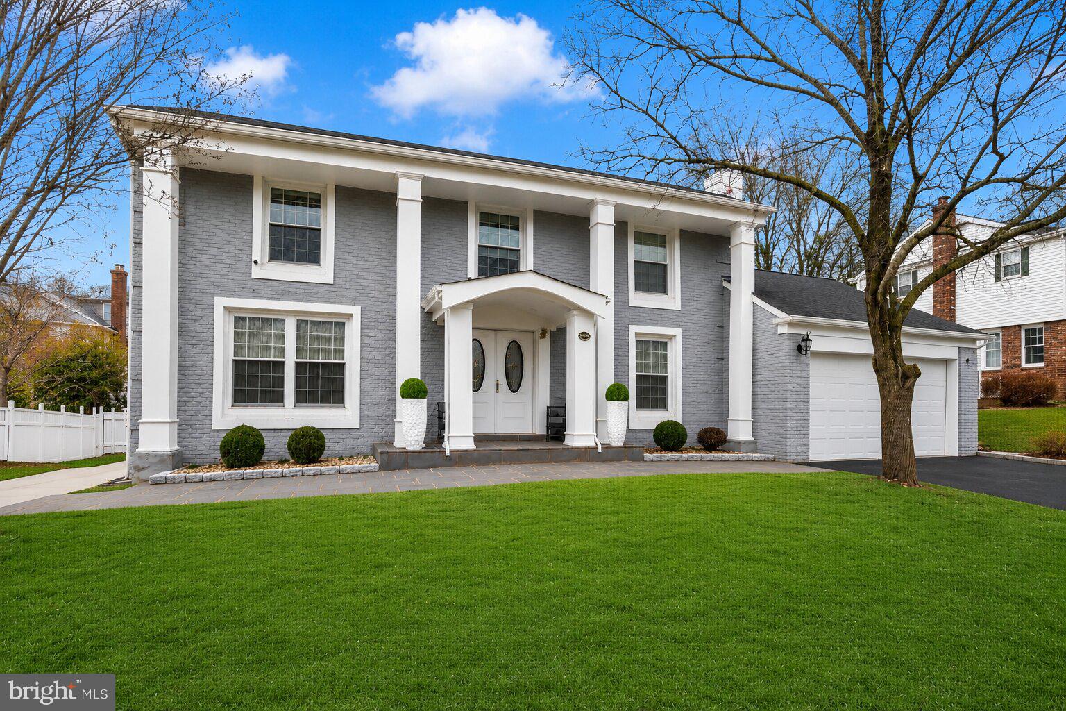 Tucked into one of Potomac's most established neighborhoods, this stunning brick Colonial has been completely reimagined, blending timeless architecture with the comfort, efficiency, and style of a modern luxury home. Offering approximately 3,500 square feet across three finished levels, this move-in ready residence features four bedrooms, three and a half baths, and extensive top-to-bottom renovations throughout. Beyond the beautiful finishes, nearly every major system has been updated in 2021, including the plumbing, electrical, windows, roof, and dual-zone HVAC, providing peace of mind for years to come. A stately columned portico and double leaded-glass entry doors welcome you into an elegant foyer showcasing oversized marble-look porcelain tile, a light oak staircase, and crown molding.  Wide-plank engineered hardwood flooring extends throughout the main level, creating a seamless and sophisticated feel. At the heart of the home is a beautifully redesigned gourmet kitchen featuring white shaker cabinetry, brushed gold hardware, Calacatta-style quartz countertops with a full-height backsplash, stainless steel appliances, a gas range with designer hood, generous prep space, abundant storage, and a waterfall peninsula with seating. The kitchen flows effortlessly into the spacious dining area, making it equally suited for everyday living and entertaining. The main living spaces are bright, open, and thoughtfully designed, highlighted by oversized windows, elegant designer wall coverings, recessed lighting, and a sleek linear fireplace. Just beyond, the sunroom offers walls of windows, painted white brick, a statement crystal chandelier, and direct access to the outdoor living space. Upstairs, the spacious primary suite serves as a private sanctuary featuring a luxurious spa-inspired bath with a double vanity, marble finishes, a frameless glass shower, and a soaking tub. The additional bedrooms are generously sized and are complemented by another beautifully renovated full bath with a double vanity, designer tile, and brushed gold fixtures. The fully finished lower level dramatically expands the home's living space with a large recreation room, dedicated fitness or flex area, an additional bedroom, and a full bath.The outdoor living spaces are equally impressive. The professionally landscaped yard features a brand-new privacy fence, newly constructed retaining walls, manicured grounds, and extensive hardscaping that creates multiple areas for entertaining and recreation. A large covered patio functions as an outdoor living room complete with recessed lighting, ceiling fans, privacy curtains, an outdoor sink and prep area, and space for grilling and dining year-round. Beyond the covered patio, the expansive concrete recreation area offers endless possibilities for basketball, pickleball, kids' play, or hosting large gatherings, all while maintaining plenty of usable outdoor space. The home's striking curb appeal is enhanced by its painted brick exterior, classic architectural columns, flagstone front walkway, mature landscaping, and attached two-car garage. Ideally located just minutes from Potomac Village, Cabin John Village, Westfield Montgomery Mall, Cabin John Regional Park, major commuter routes including I-270 and I-495, Metro access, and some of Montgomery County's most sought-after schools, including Bells Mill Elementary, Cabin John Middle School, and Winston Churchill High School. Completely renovated inside and out, with luxury finishes, major system upgrades, exceptional outdoor living spaces, and an unbeatable Potomac location, this is a rare opportunity to own a truly turnkey home in one of the area's most desirable communities.