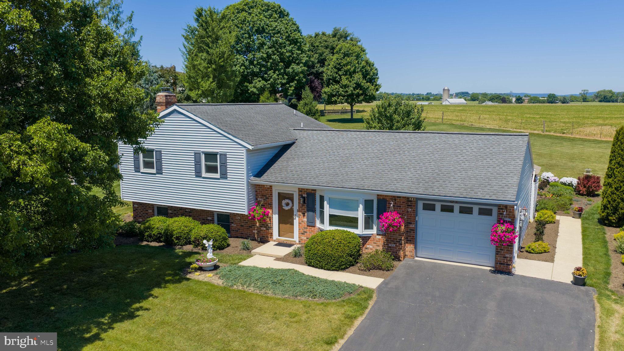 This charming split-level home with farmland views offers a perfect blend of comfort and style. This one-owner home offers 1,344 square feet of thoughtfully designed living space, this home features three inviting bedrooms and two well-appointed bathrooms, including a walk-in shower and a cozy tub shower for relaxation. Step inside to discover a warm ambiance enhanced by crown moldings and recessed lighting.  HVAC new in 2023, New roof in 2020, New hot water heater in 2023 and new windows 7 years ago. The combination kitchen and dining area is perfect for gatherings, while the spacious living room. The fully finished basement provides additional living space, ideal for a home office, playroom, or entertainment area, complete with a heatilator fireplace and glass doors and a rear exterior entrance to back yard. Enjoy the ease of laundry on the lower floor, making daily chores a breeze. Outside, the lot boasts beautifully landscaped grounds and a premium rear yard with a sprawling amish farm on the other side of the fence, perfect for outdoor activities or quiet moments of reflection. Parking is a breeze with an attached garage and ample driveway space for guests.  Experience the perfect blend of comfort, style, in this delightful property.