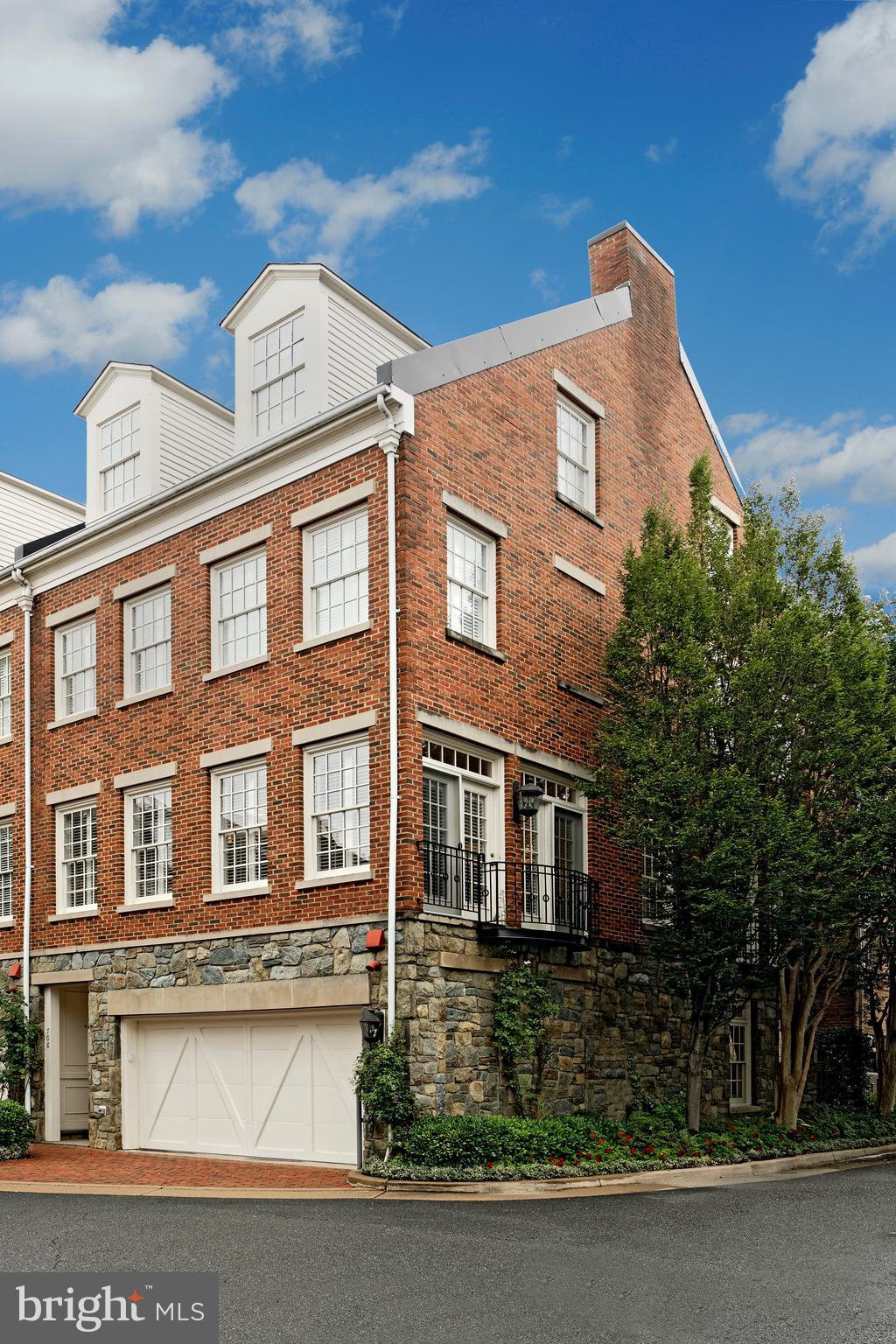 Rarely available, Potomac model end unit townhouse in Fords Landing!  Largest of the designs in this sought-after neighborhood, the sun-drenched home features 4 spacious bedrooms, 3 full and 2 half baths and a newly renovated kitchen with island.  Floor to ceiling windows, French doors plus its southern corner location contribute to the abundance of natural light in all rooms.  Hardwood floors throughout all four levels, plantation wood shutters, exceptional renovated baths and powder rooms will please the most discriminating buyer.   An interior elevator from the garage level to the master suite is a wonderful addition.   Exceptional windows anchor the expansive living room and dining room with wide crown molding in an open floor plan, perfect for family living or entertaining.  A Juliet balcony offers a side view of the Potomac River.  The renovated chef's kitchen offers lighted custom cabinets, an island with gas cooking and a grill top, cold drink refrigerator drawer, extra freezer drawer plus warming oven along with JennAir appliances.  Vaulted ceilings are dramatic in the master suite with a private balcony with a river view, several closets and gorgeous new master bath with seamless glass shower door and  beautiful double sink vanity with special lighting.  A convenient laundry is on this master floor.  Three additional guest rooms are very inviting and bright with  great closet space, ceiling fans and hardwood floors.   A family room on the lower level is a marvelous gathering spot featuring a new large screen Samsung TV which conveys and doors that open to the brick patio for outside enjoyment.  An attached 2-car garage completes this fine residence.