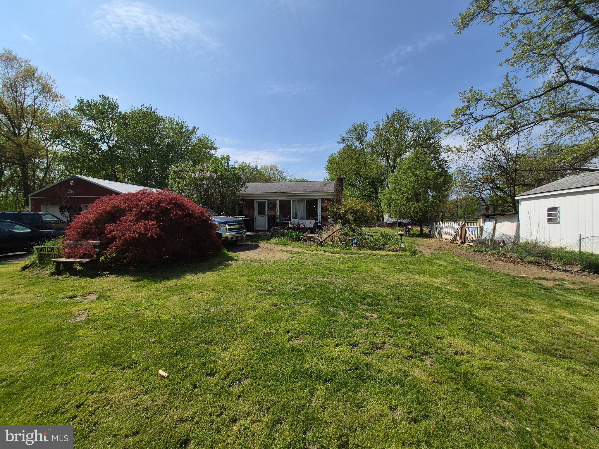 Discover the charm of this 1960 ranch-style home, nestled on a sprawling 3.33-acre lot. This detached residence features three bedrooms and a spacious bathroom, perfect for comfortable 1-level living. The main floor laundry adds convenience to your daily routine. An unfinished basement offers plentiful storage, while the expansive outdoor space includes a patio and tons of yard for relaxation and entertaining. A large pole barn provides space for four-vehicle parking, storage, or work space, complimented by an second storage shed. Enjoy the tranquility of country living while being just a short drive from local amenities. Embrace the potential and make this home your own!