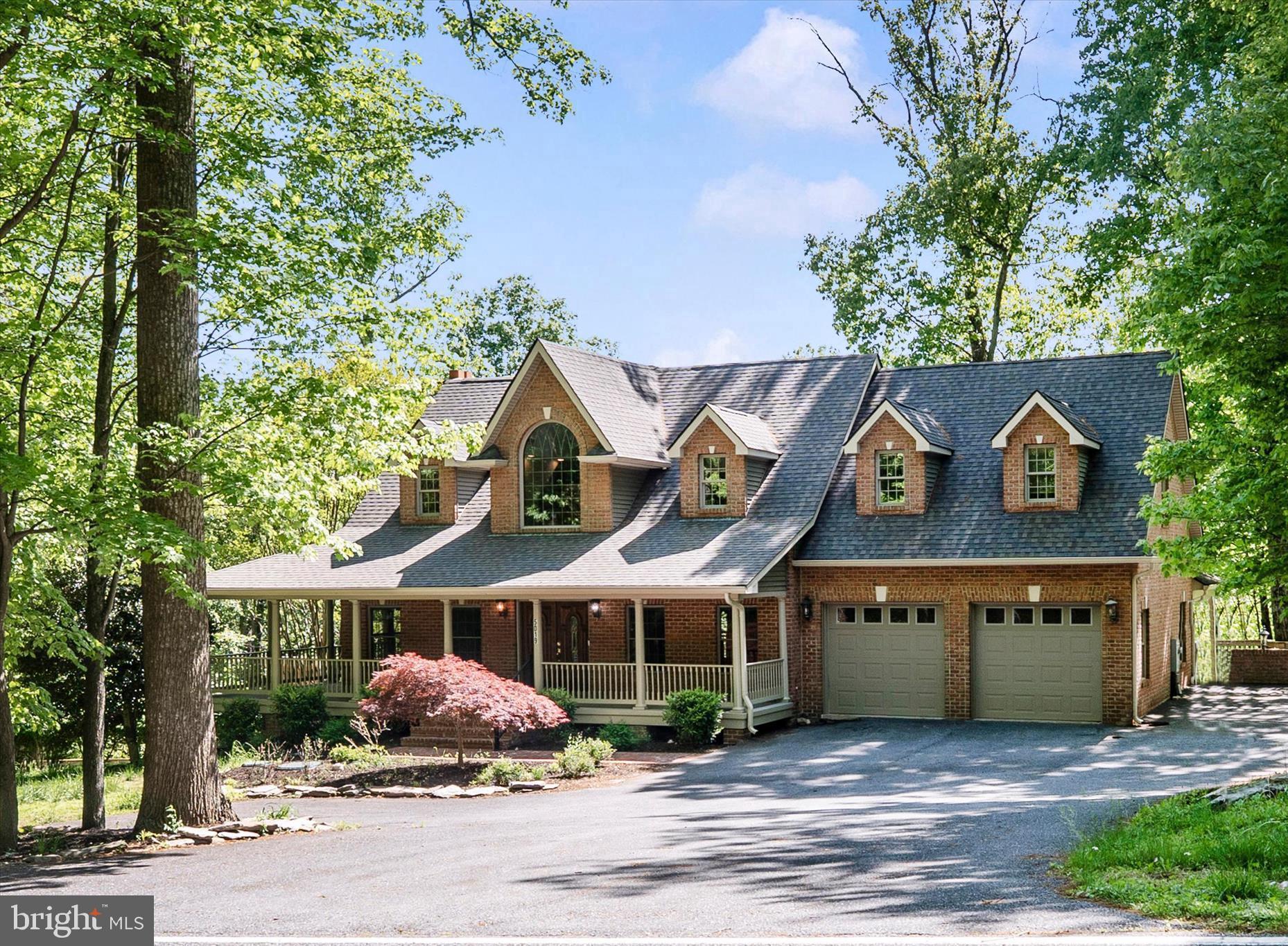 Welcome to This Magnificent Brick Cape Cod in Frederick! Discover the perfect balance of secluded tranquility and modern convenience.  Set on nearly three sprawling, wooded acres, this fabulous home offers a "worlds away" feel while remaining just 1.5 miles from Frederick city limits and major commuter routes like I-70. With over 5,000 square feet of finished living space, this home showcases high-end finishes, including rich, stain-grade oak trim, solid-core doors, and a grand stairway off the foyer. A seamless blend of classic hardwoods and durable Luxury Vinyl Plank (LVP) throughout the home. The kitchen has premium stainless steel appliances and abundant natural light from large windows. The main-level flex room with its own private entrance is ideal for a quiet workspace, client meetings, or you could switch out the doors and make it another bedroom!! The lower level is designed for year-round recreation and wellness. The expansive open space is designed as a wet room of sorts, with a "closet shower" and a half bath. The huge recreation room overlooks the rear deck and the natural flow directly into the pool area—perfect for parties or private therapy. The wall of sliding glass doors can be opened in the summer for an outdoor feel! The pool has been converted to a saltwater pool for minimal upkeep. Over 4,000 square feet of combined decking, patios, and covered porches, providing endless space for summer BBQs or quiet mornings in the woods. In addition to the 2-car attached garage, the property includes a 2-car detached garage with a spacious one-bedroom apartment above. This versatile space is perfect for a long-term rental, an Airbnb, or a private guest wing. If you seek privacy, tranquility, and a home built for both relaxation and hospitality, this Frederick gem is a must-see.