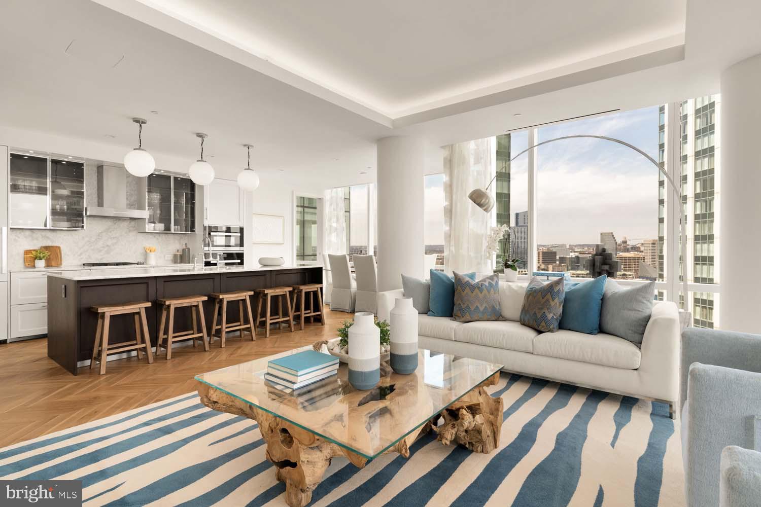 TWO-BEDROOM CORNER UNIT MODEL  WITH BALCONY AVAILABLE!
Welcome to the Four Seasons Private Residences in Harbor East, where luxury meets lifestyle in Baltimore’s most coveted waterfront address. Perched above the city in a prime corner location, this exceptional two-bedroom, two-bathroom residence offers breathtaking views of the Inner Harbor and sweeping city skyline from nearly every room. With floor-to-ceiling windows that bathe the home with natural light, and a private balcony, the ever-changing waterfront scenery becomes part of your daily living experience. Thoughtfully designed to utilize every inch with purpose, this unit lives larger than 1,685 sq ft! Step into an atmosphere of sophistication with soaring ceilings, rich walnut chevron-patterned flooring, and designer finishes throughout. The gourmet kitchen is a chef’s dream, outfitted with Miele appliances, sleek Eggersmann soft-close cabinetry, luxurious marble stone countertops, and a built-in Sub-Zero wine fridge - perfectly blending timeless elegance with modern function. The primary suite is a tranquil sanctuary, offering two custom-built walk-in closets for optimal storage and a spa-inspired, marble-clad en-suite bath featuring a double vanity with designer finishes, a glass-enclosed walk-in shower with a built-in bench and niche, separate water closet, and a sculptural freestanding soaking tub that invites total relaxation. The second bedroom offers equal comfort and privacy with its own full bath and ample storage. Every inch of this home is elevated by exceptional attention to detail, all complimented by an absolutely breathtaking waterfront backdrop. 

The Four Seasons Private Residences Baltimore offers a turn-key elevated lifestyle. As a resident, you'll enjoy a private entrance where you will be met by our full service concierge and on-site building manager to assist with your every need, as well as exclusive access to the sprawling 28th-floor amenity level, where world-class services meet resort-style indulgence. Amenities include an indoor heated saltwater infinity-edge pool, a state-of-the-art fitness center, sauna, coffee station, billiard room, and numerous elegant gathering spaces. Multiple rooftop decks offer panoramic city and harbor views, complete with indoor and outdoor fireplaces, a grilling station, a dining area, and a kitchen, all ideal for entertaining. Completing this unparalleled lifestyle experience are a fully equipped conference room and a dedicated AstroTurf dog-walking area. This residence offers the rare opportunity to live within a full-service, hotel-branded building while enjoying the privacy and sophistication of a true luxury home. All set within steps of Harbor East’s acclaimed restaurants, shopping, and the waterfront promenade. This is a MUST SEE TWO BEDROOM!! Immediate occupancy is available. Come see what all the fuss is about!